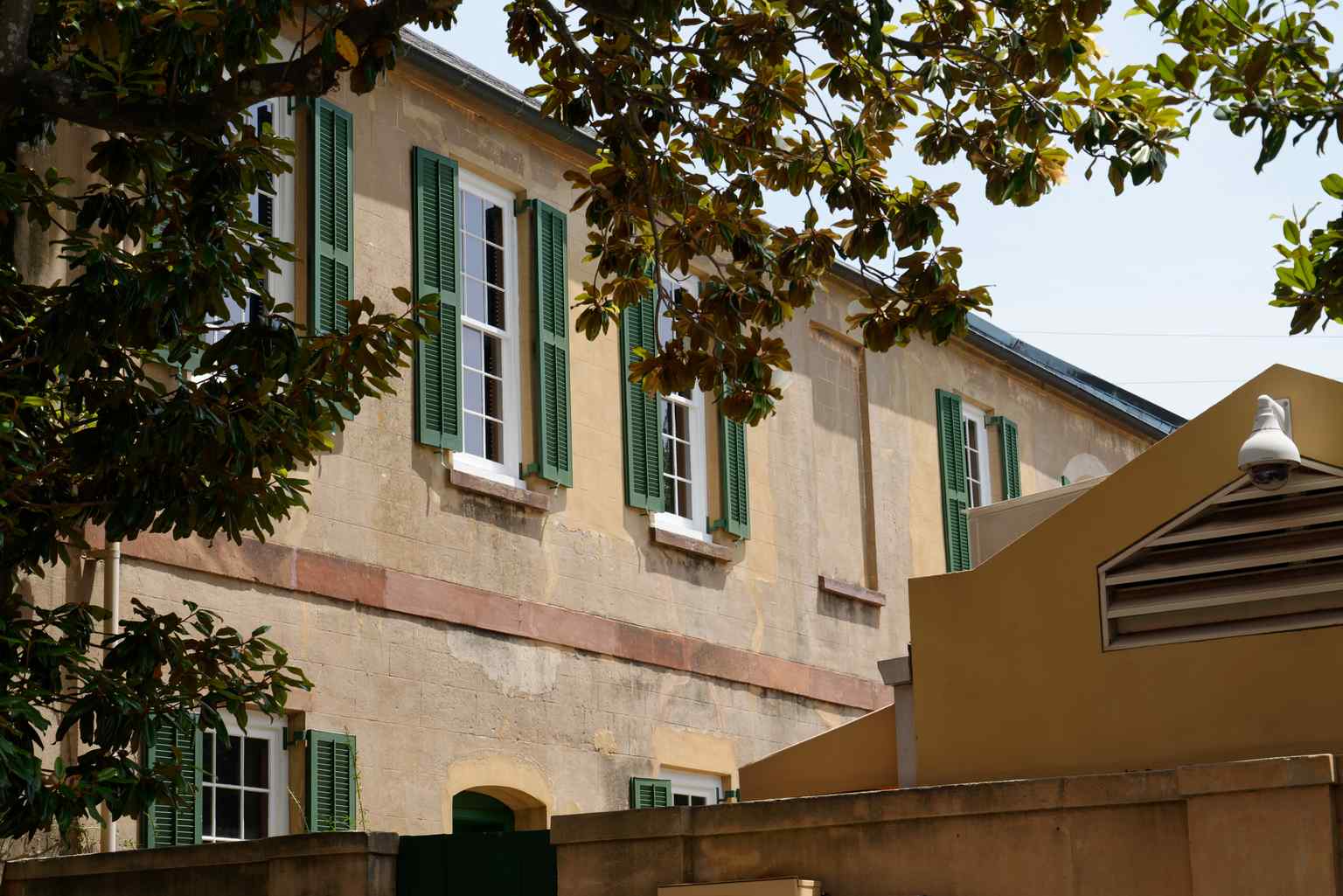 A view of the historic slave quarters, where individuals like Peter, Diane, and Emma lived and worked, their lives starkly contrasting the main house's elegance.