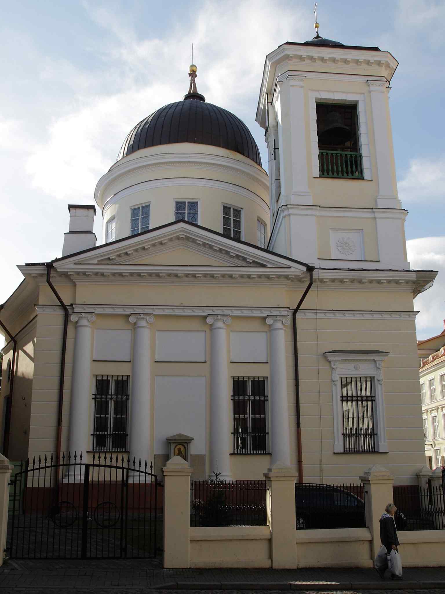 Another historical view of the church and its gate area, echoing the fortified urban setting of Tallinn’s Old Town around the parish grounds.