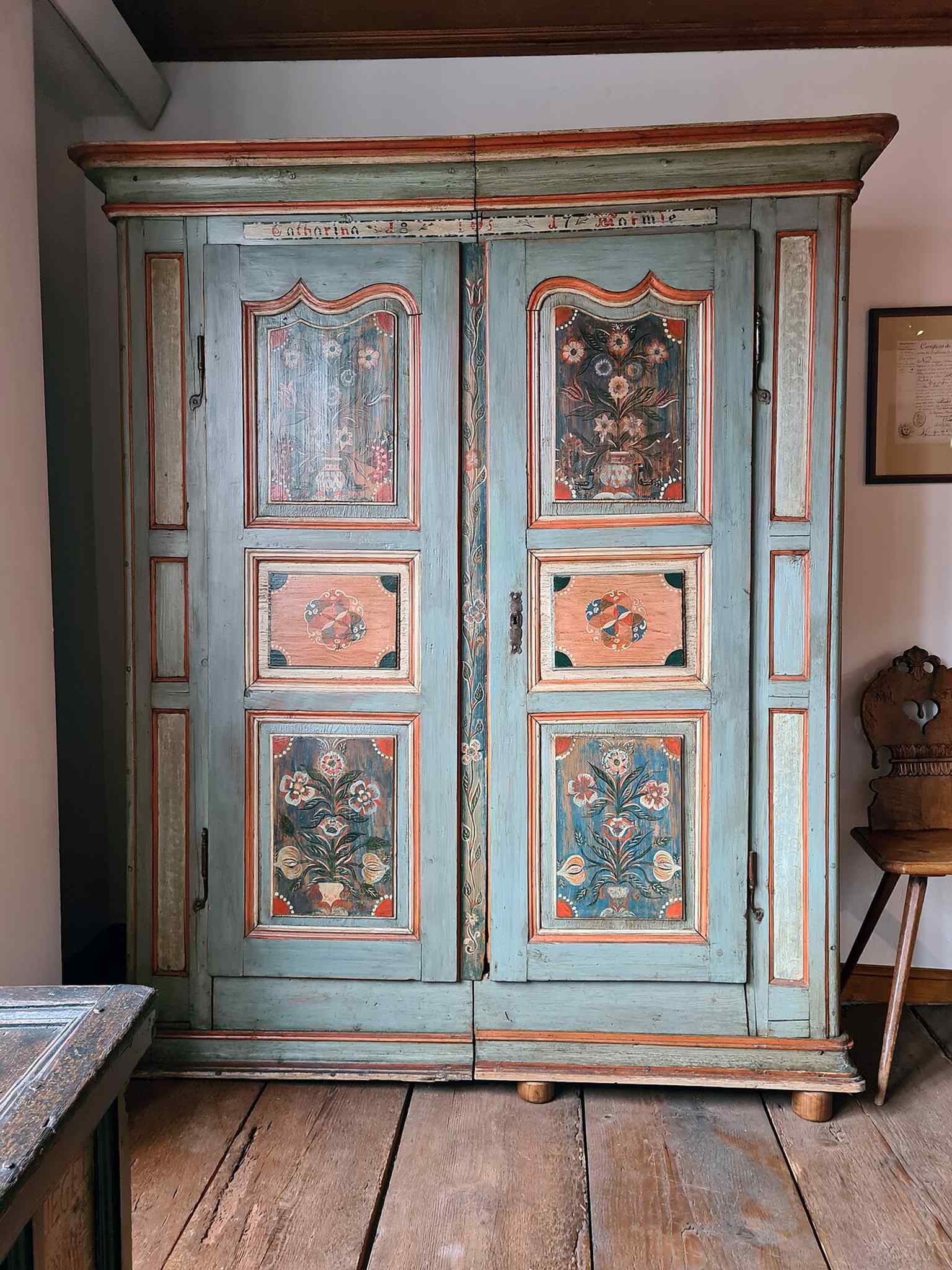 A wedding wardrobe from Sundhoffen, typical of the richly decorated furniture used to mark marriage and household status.
