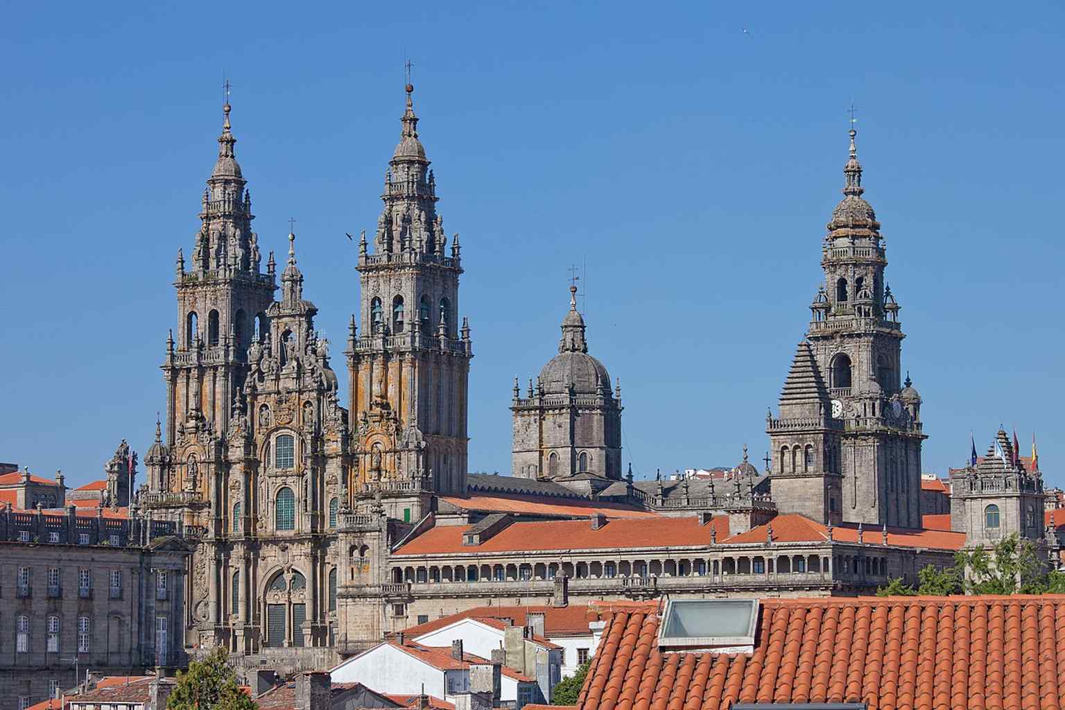 The iconic Baroque Obradoiro facade, designed by Fernando de Casas Novoa, stands as a symbol of Santiago de Compostela and is featured on Spanish Euro coins.