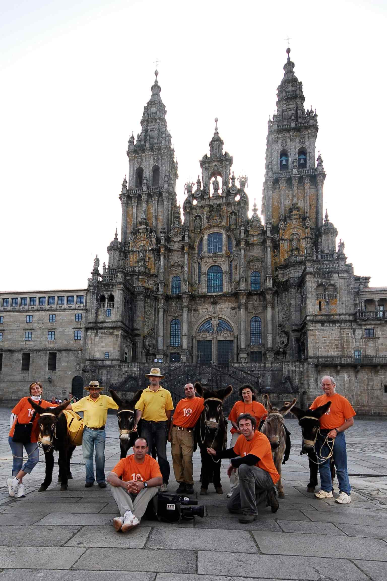 Pilgrims, some arriving on donkeys as in medieval times, gather in front of the Cathedral, culminating their spiritual journey on the historic Camino de Santiago.