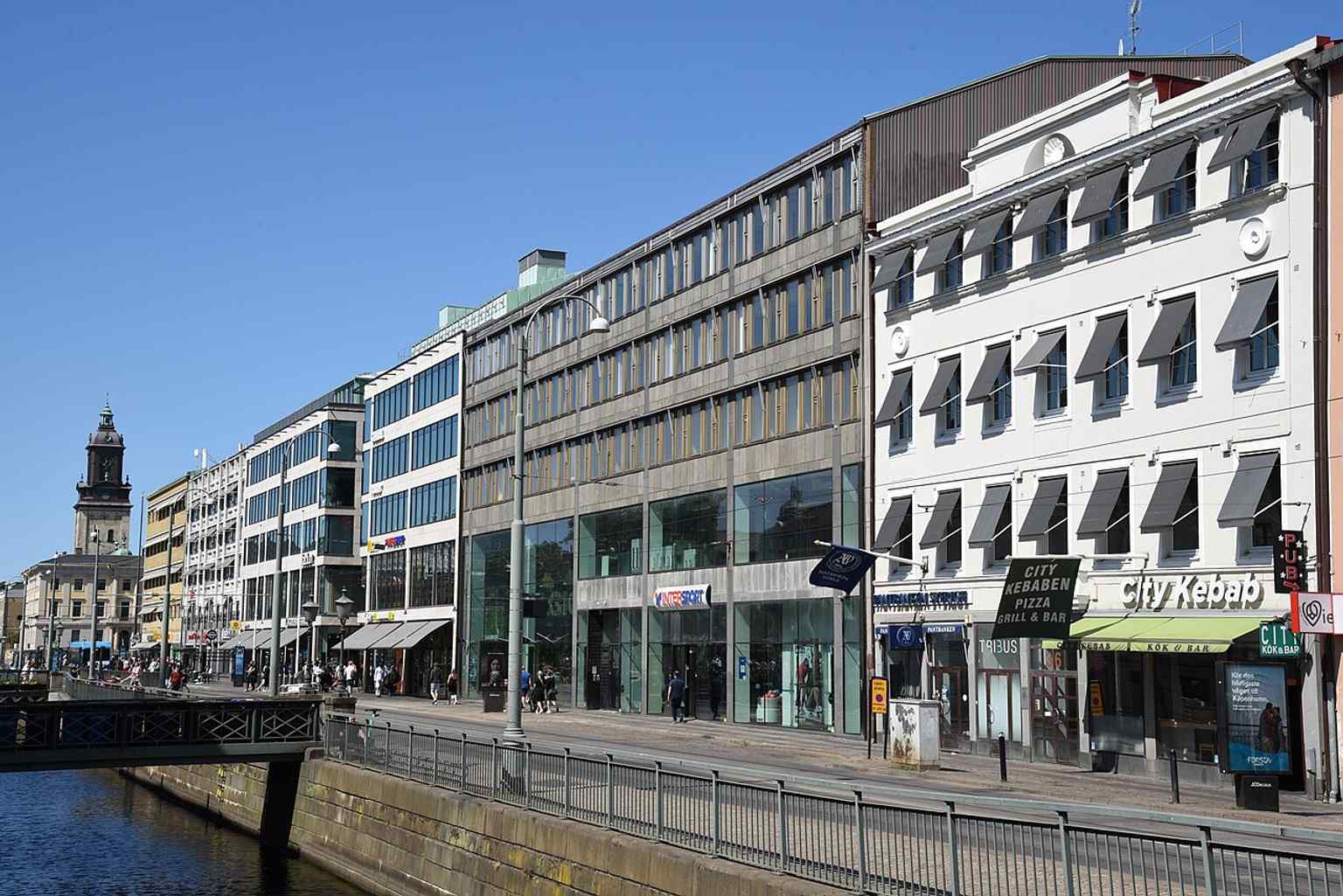 A modern view of Norra Hamngatan 18-36, featuring contemporary buildings such as Thulehuset (built 1937) and the main entrance to the Nordstan shopping center.