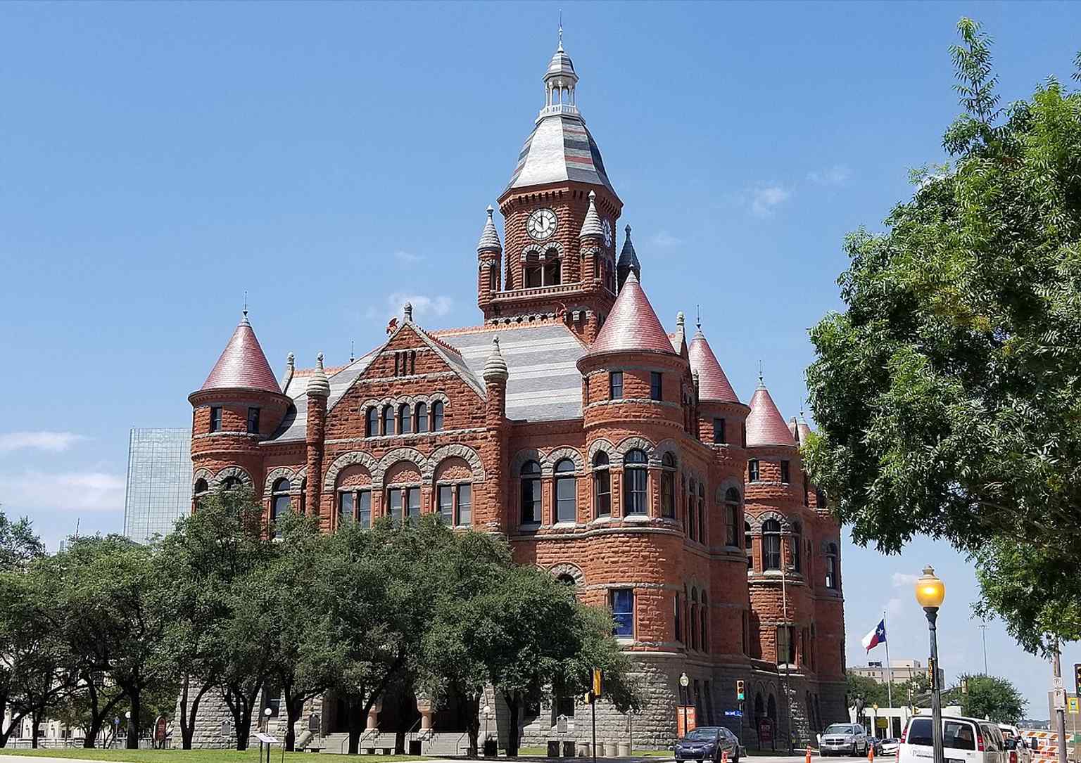 The courthouse crowned with a Texas flag, showing the tower that made Old Red a Dallas icon before the original clock tower was removed in 1919.