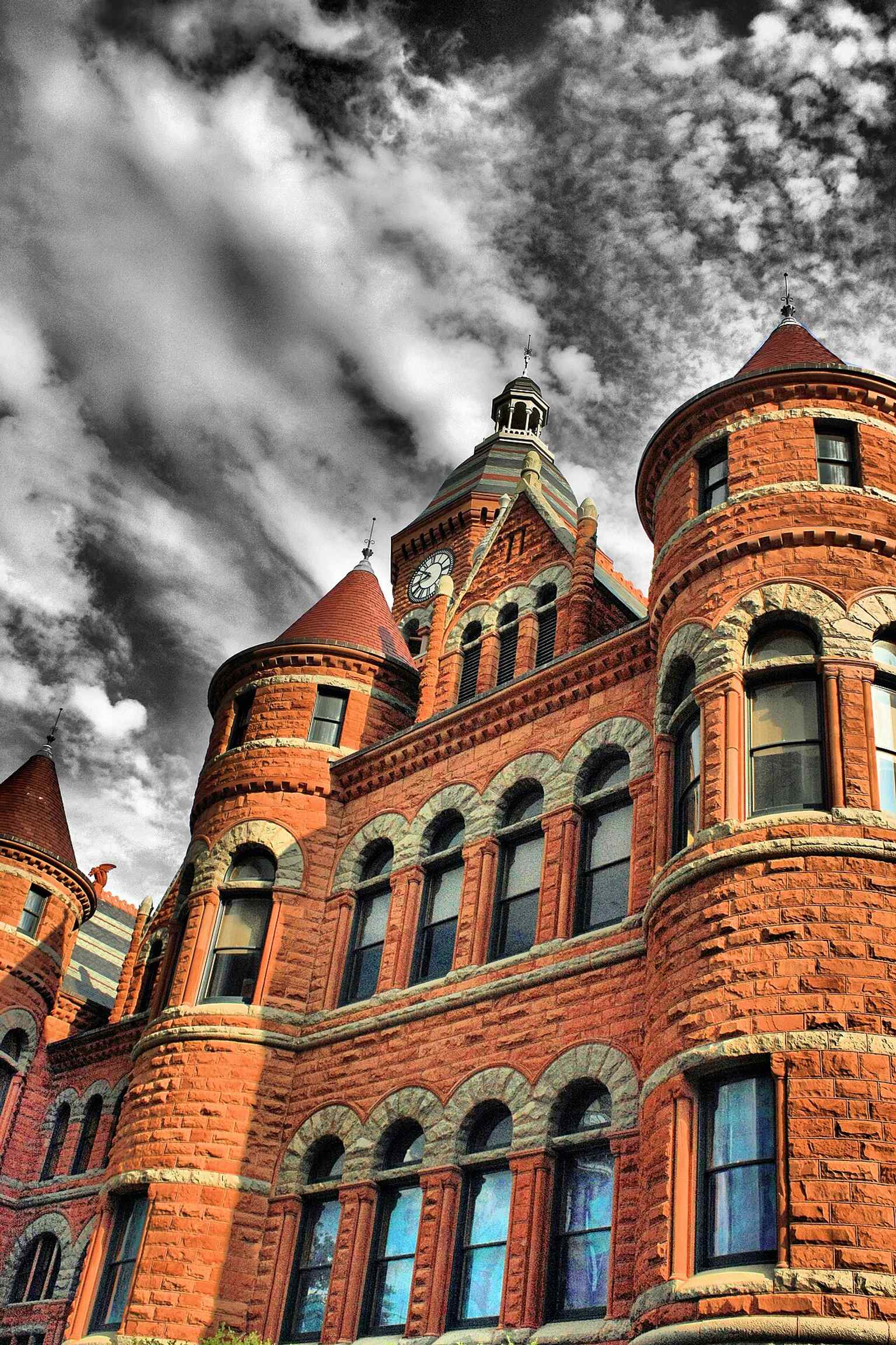A dramatic close-up of Old Red’s Richardsonian Romanesque stonework, the heavy masonry chosen after four earlier courthouses were lost to fire.
