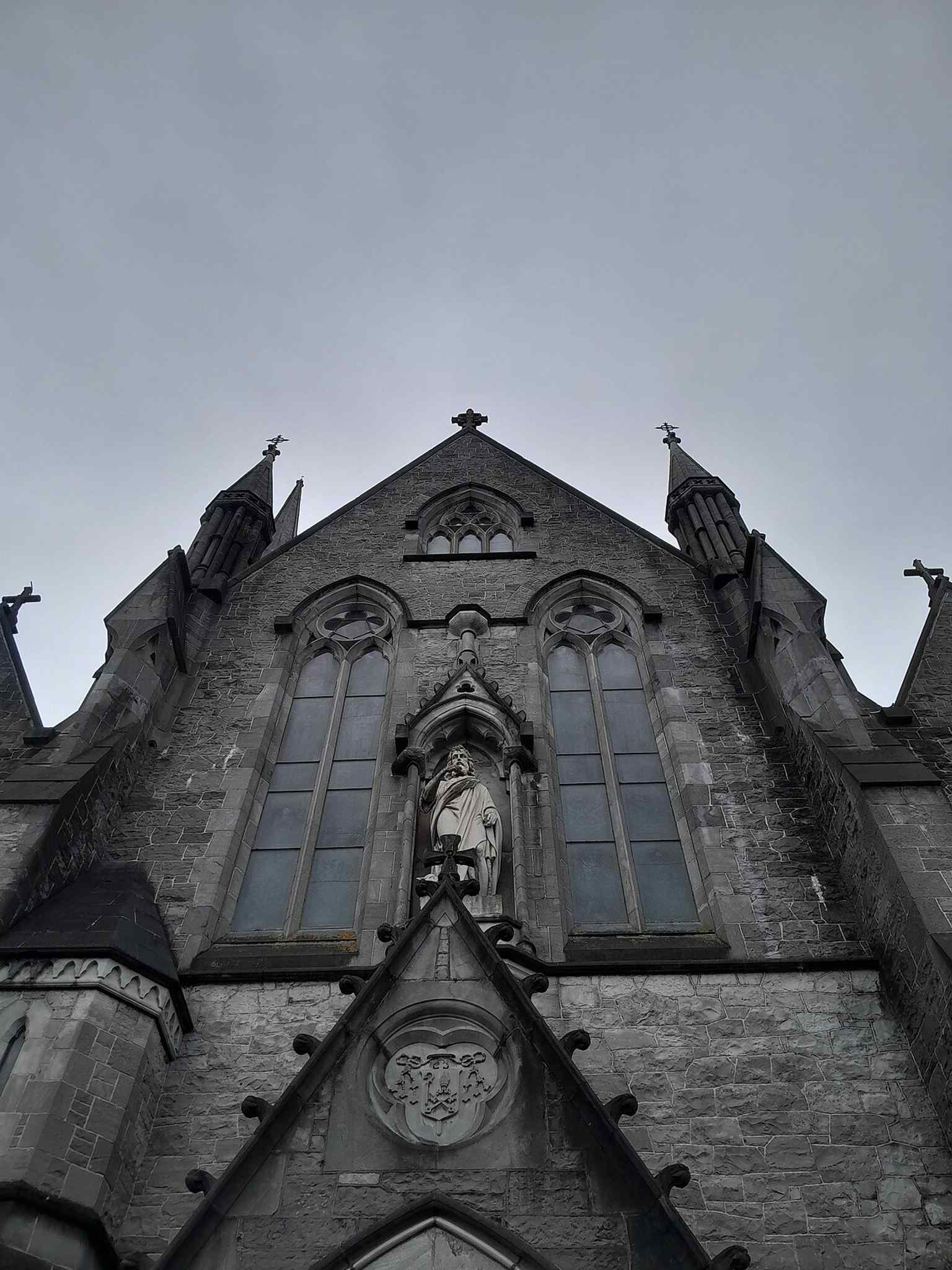 A bright exterior view showcasing the cathedral's local limestone facing and roofline, which underwent restoration work in 2003/2004.