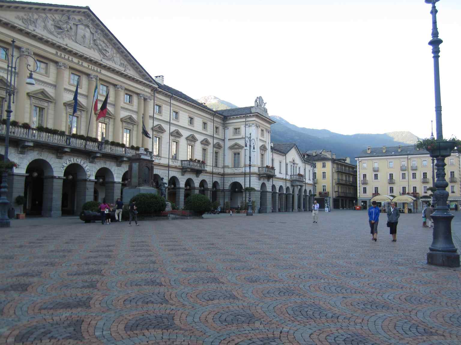 A contemporary view of Place Émile Chanoux from the west, showcasing the main square of Aosta.