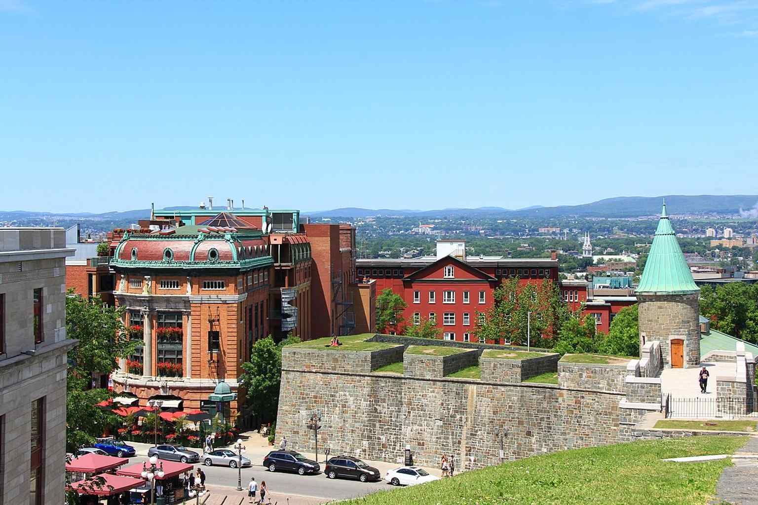 A broad view from the city ramparts, placing the Capitole in its fortified Old Quebec setting near Porte Saint-Jean.