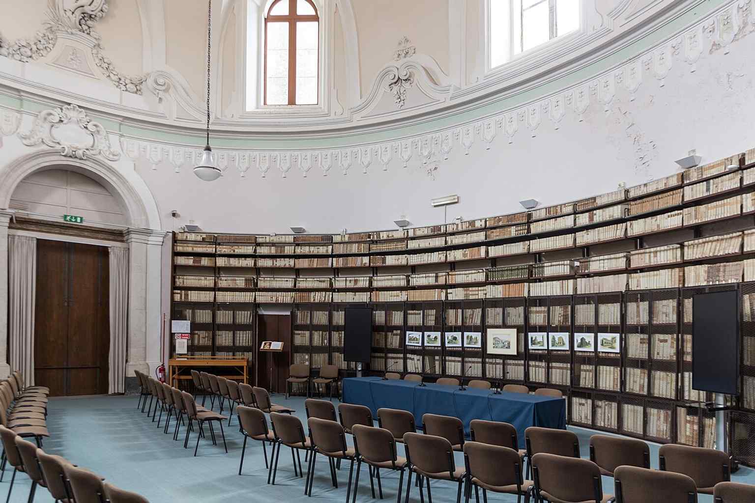 A second view of the Corridoio dell’Elefante, linking the library to the wider Benedictine monastery and its monumental interiors.