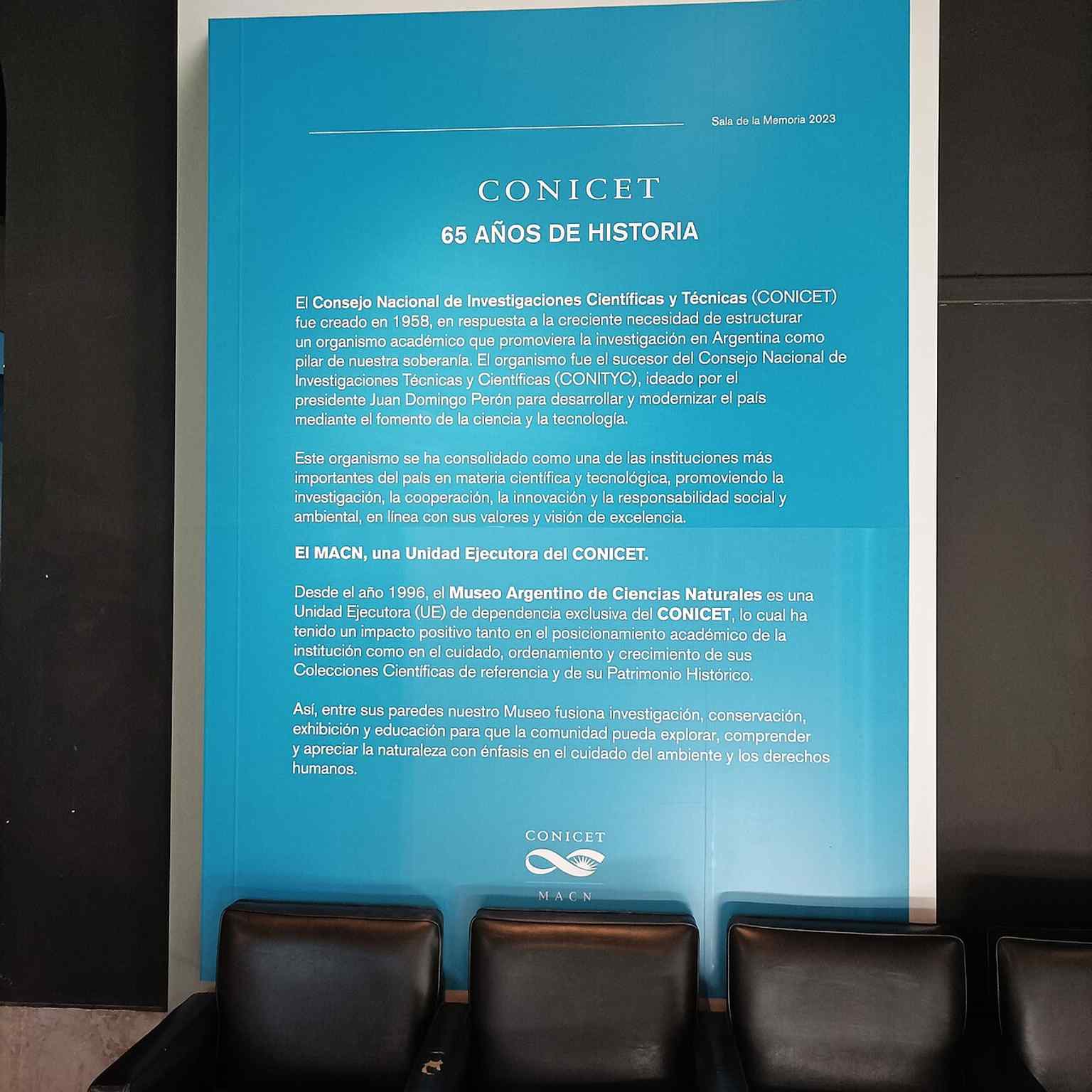 This sign celebrates 65 years of CONICET, highlighting the museum's crucial role as an executive unit of Argentina's National Council for Scientific and Technical Research.