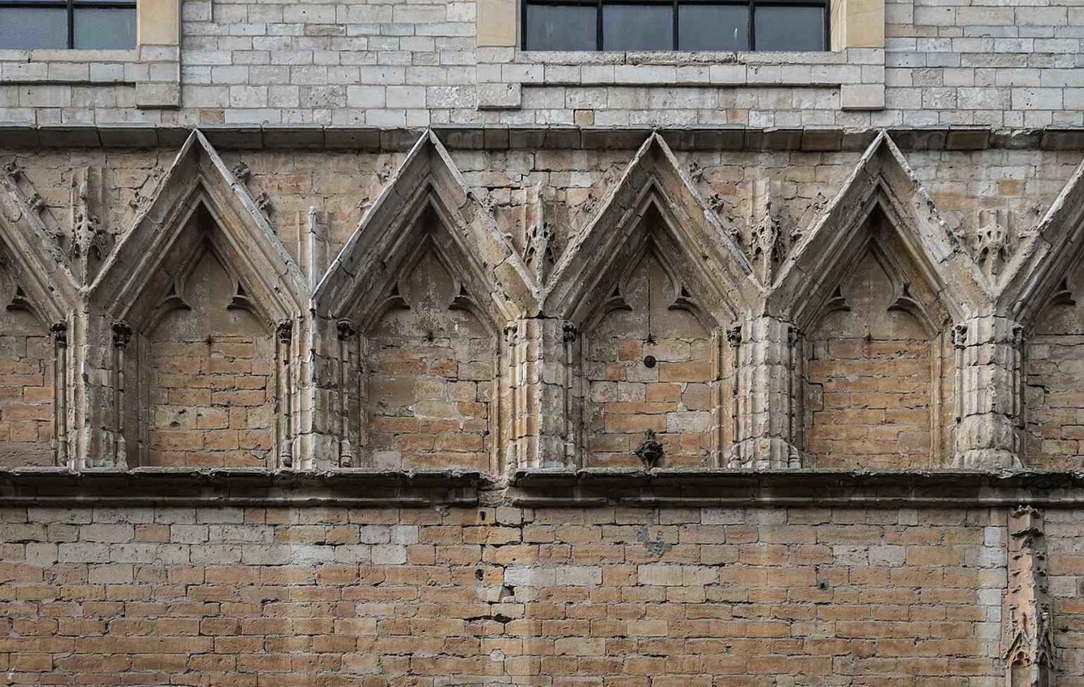 Architectural details on the front façade, ideal for showing the decorative stonework of the historic university hall.