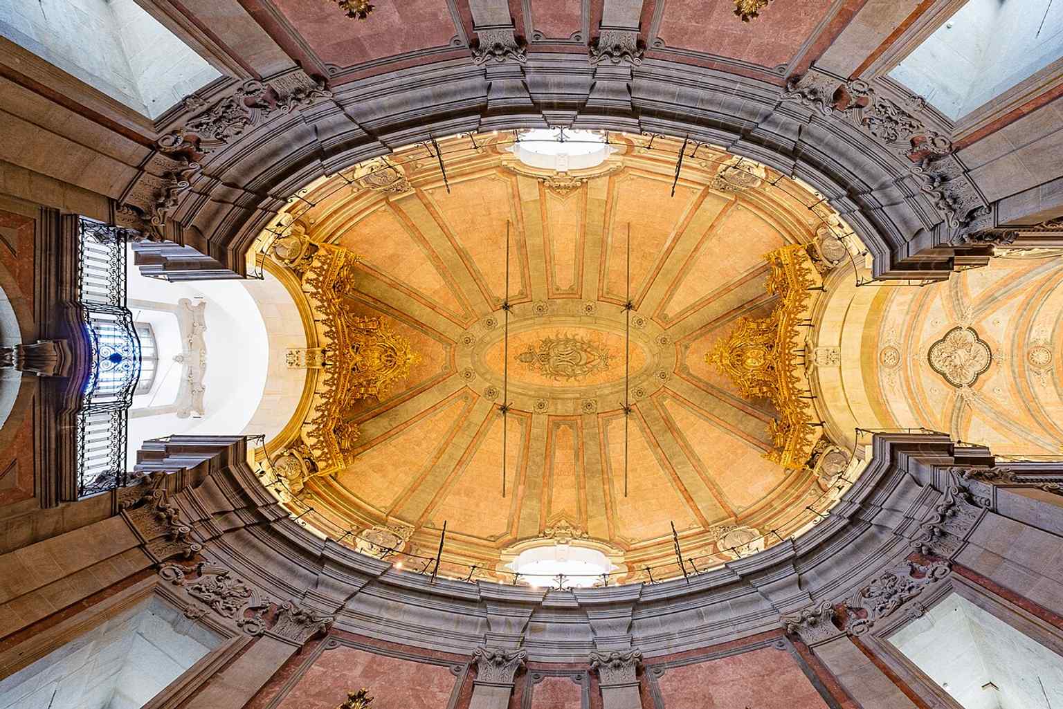 The painted ceiling, part of the church’s elaborate interior program that leads the eye upward above the gilded altars.