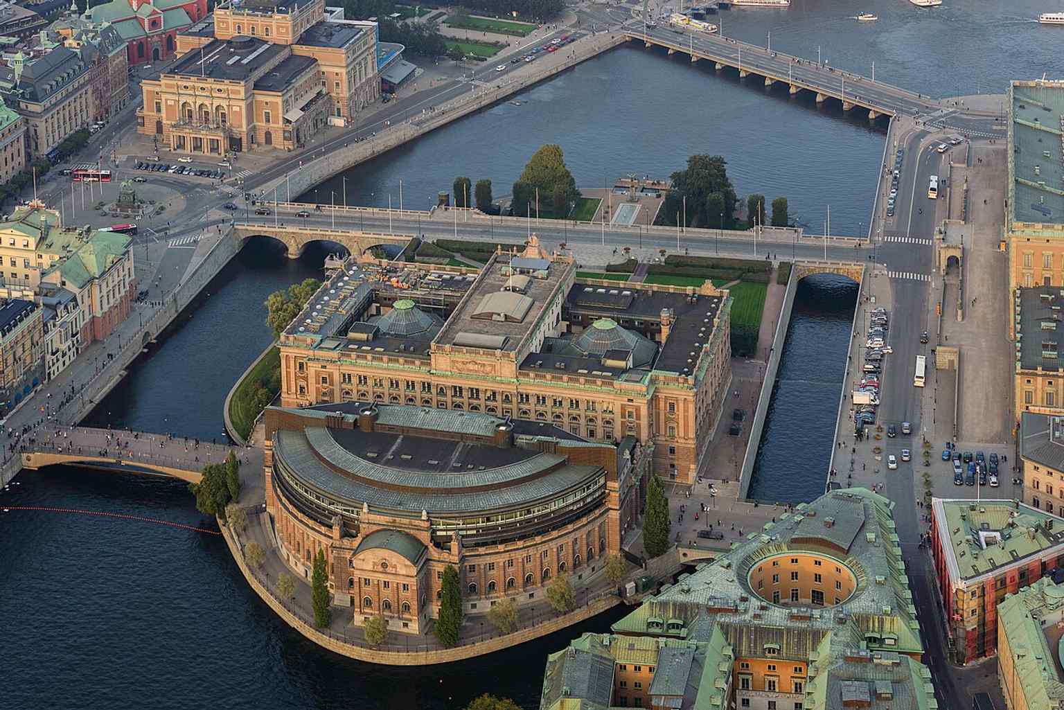 An overhead view from 2014 captures the parliament complex and surrounding streets, useful for explaining how the Riksdag sits between Norrbro and Riksplan.