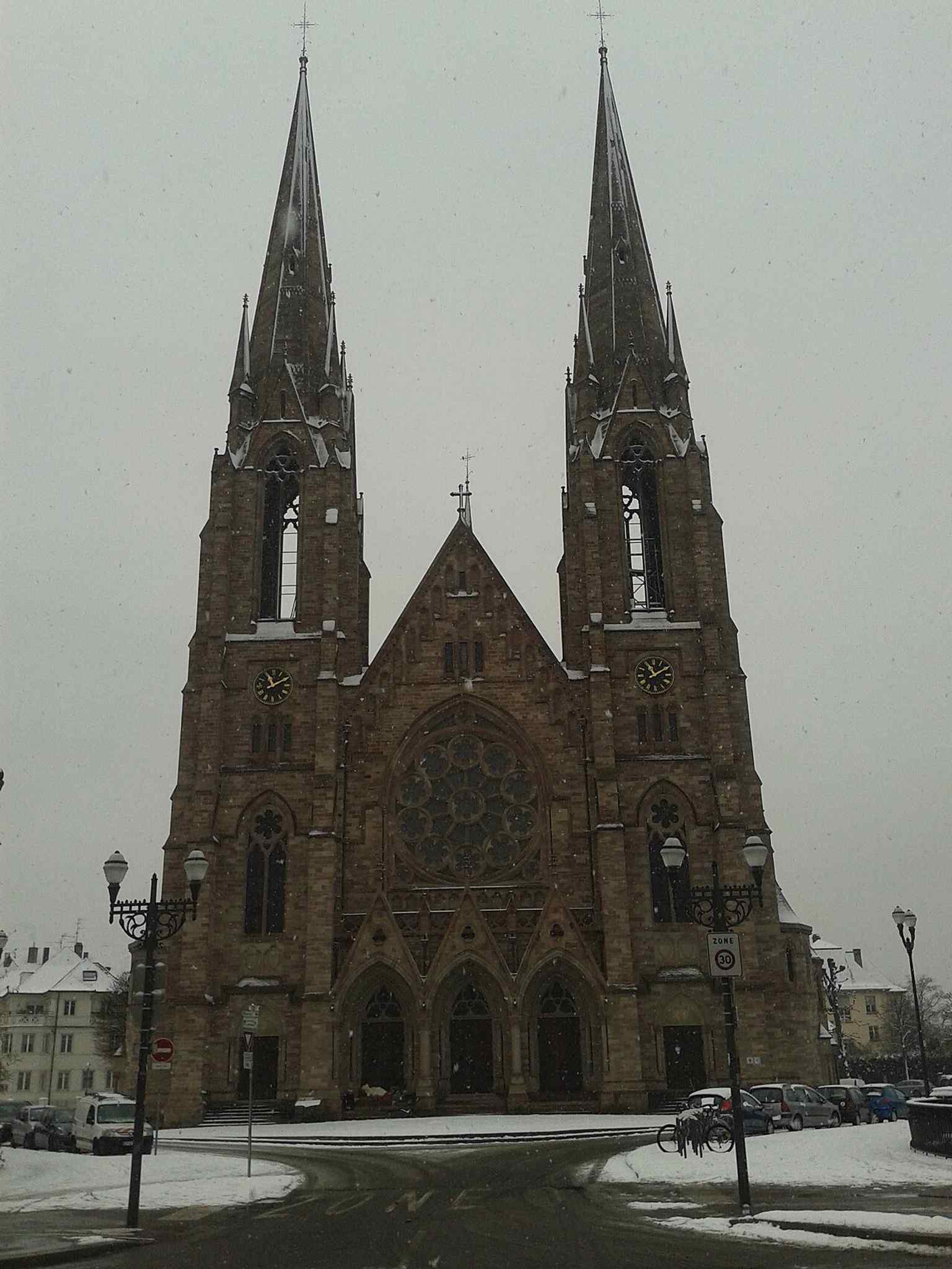 A street-level view of the church, giving a modern sense of its height and neo-Gothic presence.
