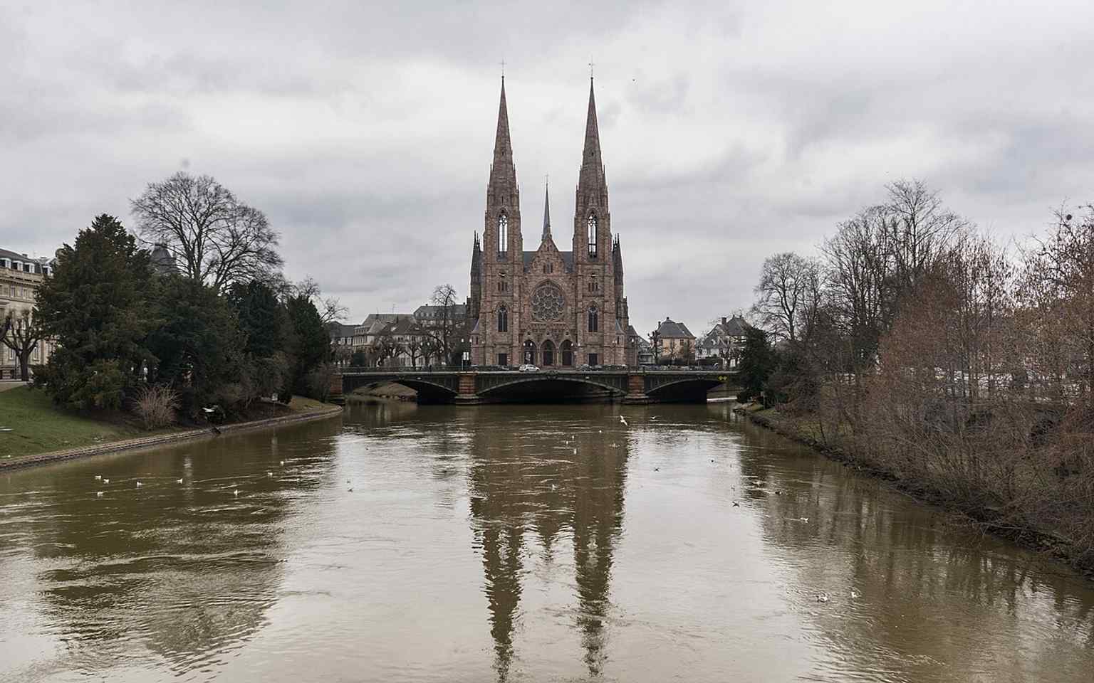 A wide west-facade view that highlights the church’s soaring vertical lines and twin spires.