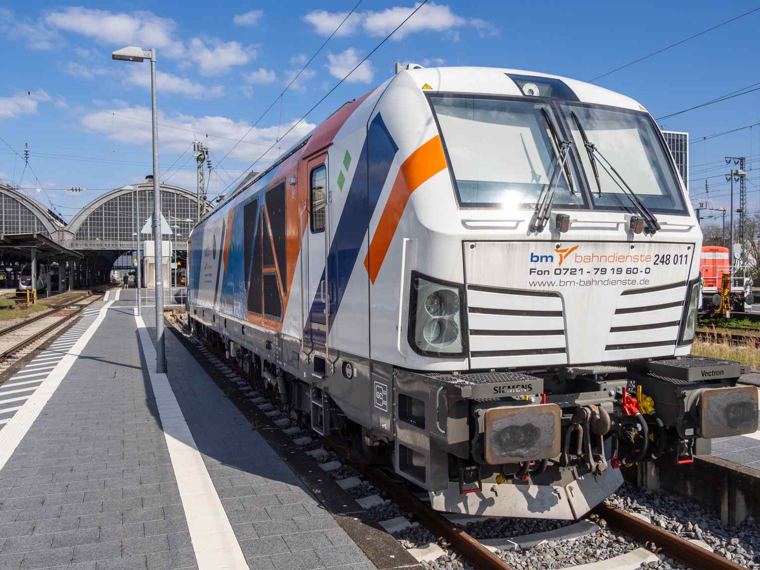 A modern Siemens Vectron Dual Mode locomotive at Karlsruhe Central Station, showcasing the diverse range of rolling stock, including those for private operators, that utilize this busy rail junction.