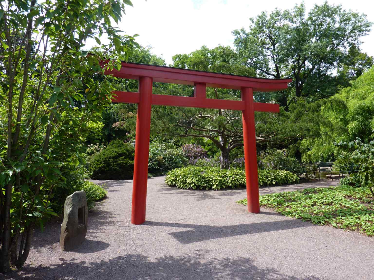 The striking red Torii gate marks the entrance to the Japanese Garden, which began construction in 1918 and was later enhanced with authentic elements from Nagoya in 1927.