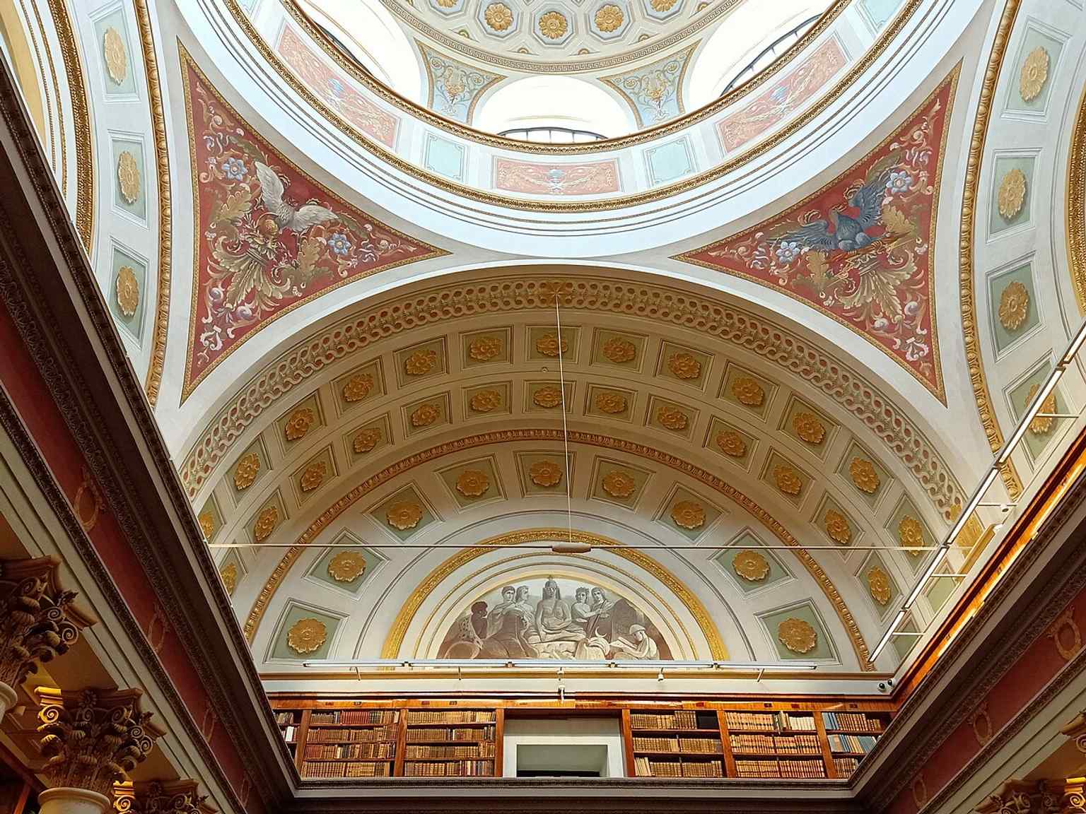 Another dome interior angle that shows the scale of the cupola and the layered restoration of the historic space.