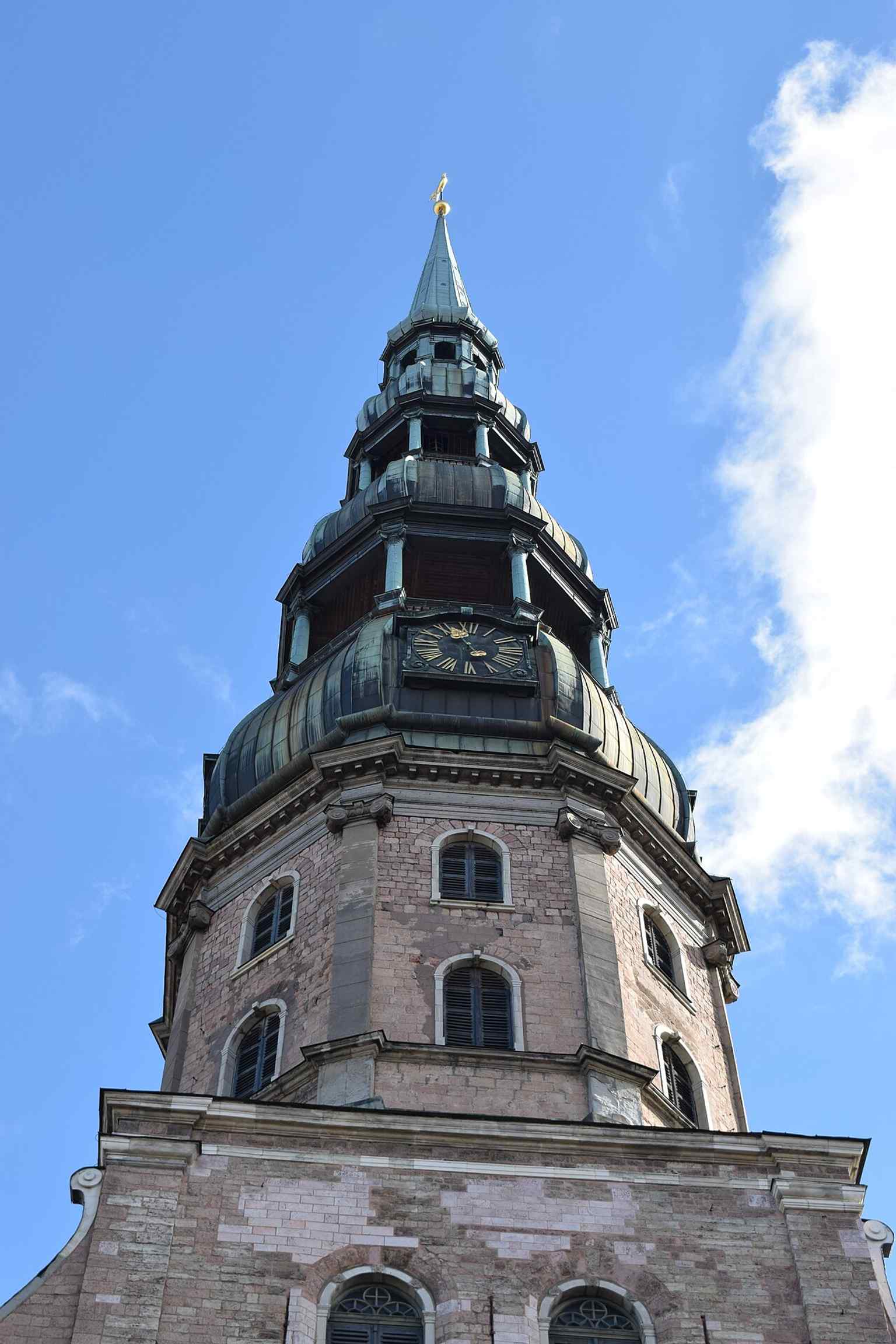 The tower close-up highlights the church’s dramatic vertical profile and the rebuilt spire that now defines the Riga skyline.