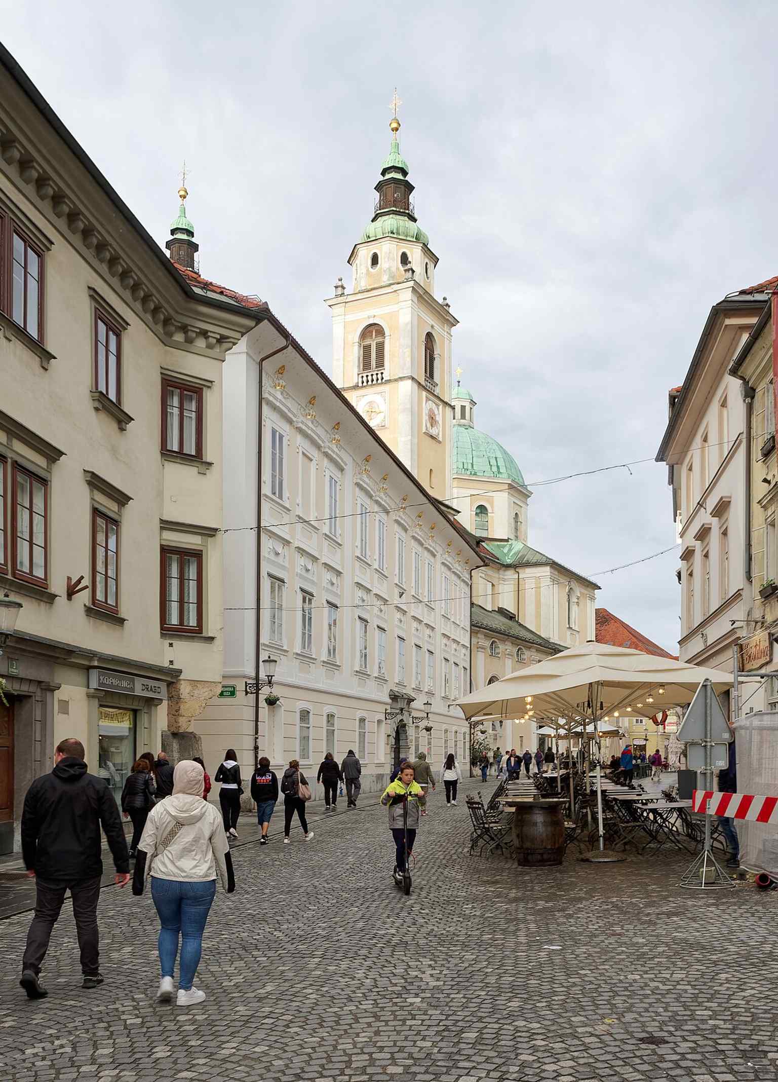 Ljubljana Cathedral, with its distinctive green dome and twin towers, stands prominently in Cyril and Methodius Square, an easily recognizable landmark of the city.