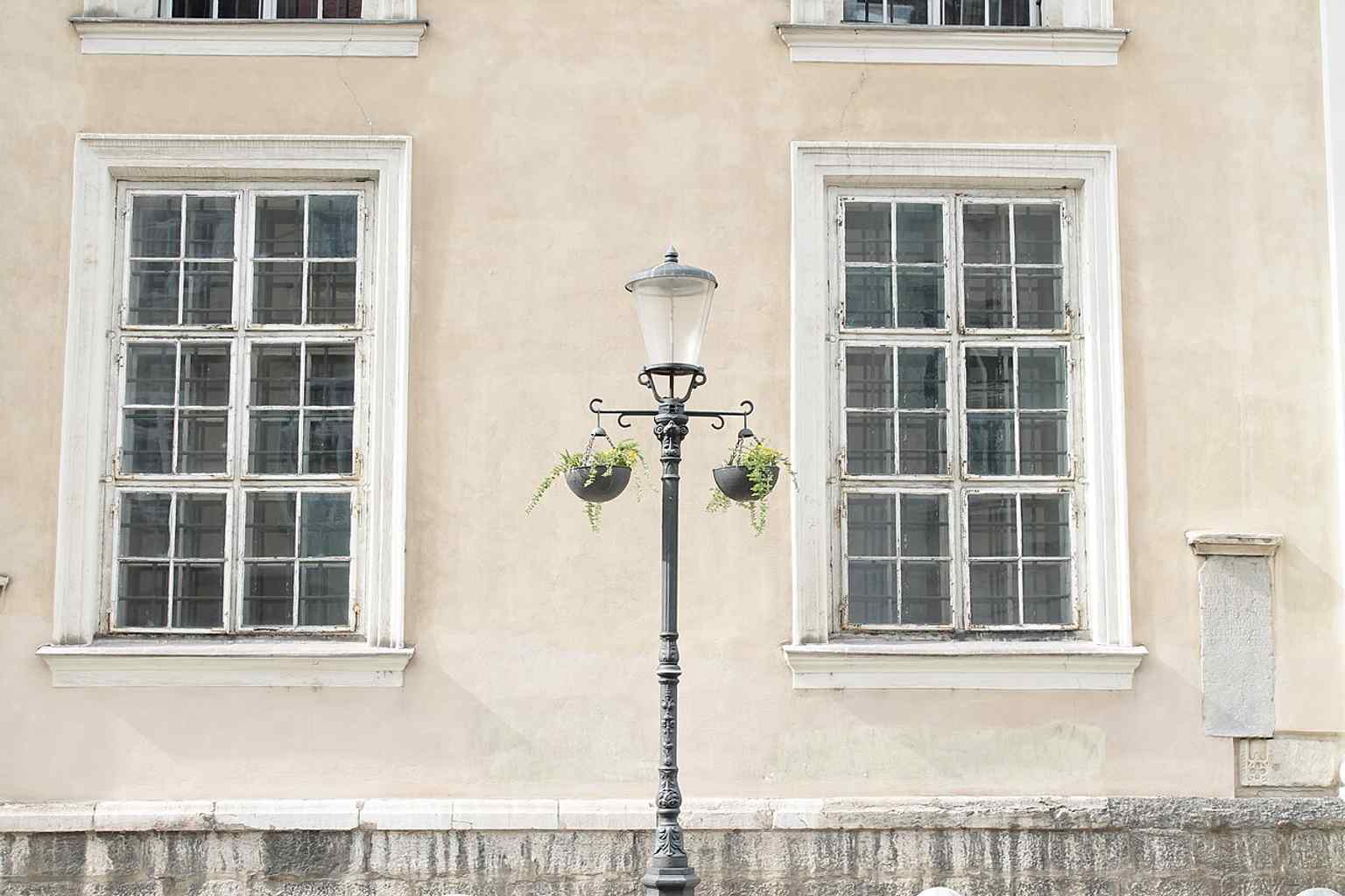 View the southern facade, which features the historic sundial and the niche containing a copy of the Gothic Pietà.
