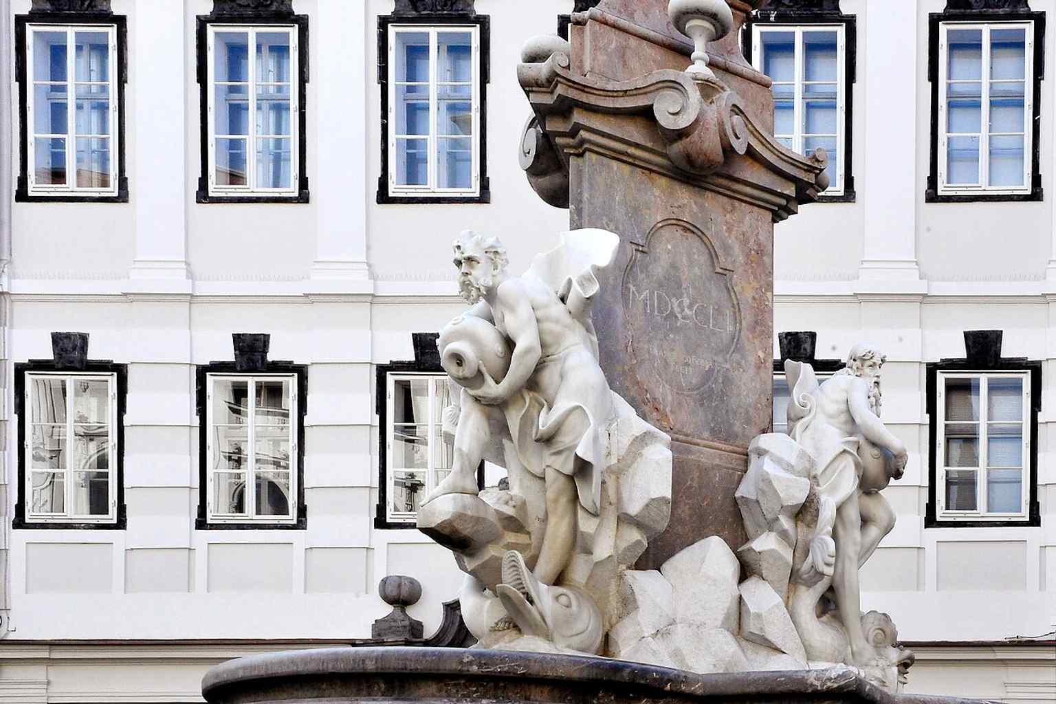 A detail shot highlighting the muscular male figures, each holding a water jug and accompanied by a dolphin, symbolising the rivers and territorial units of Carniola.