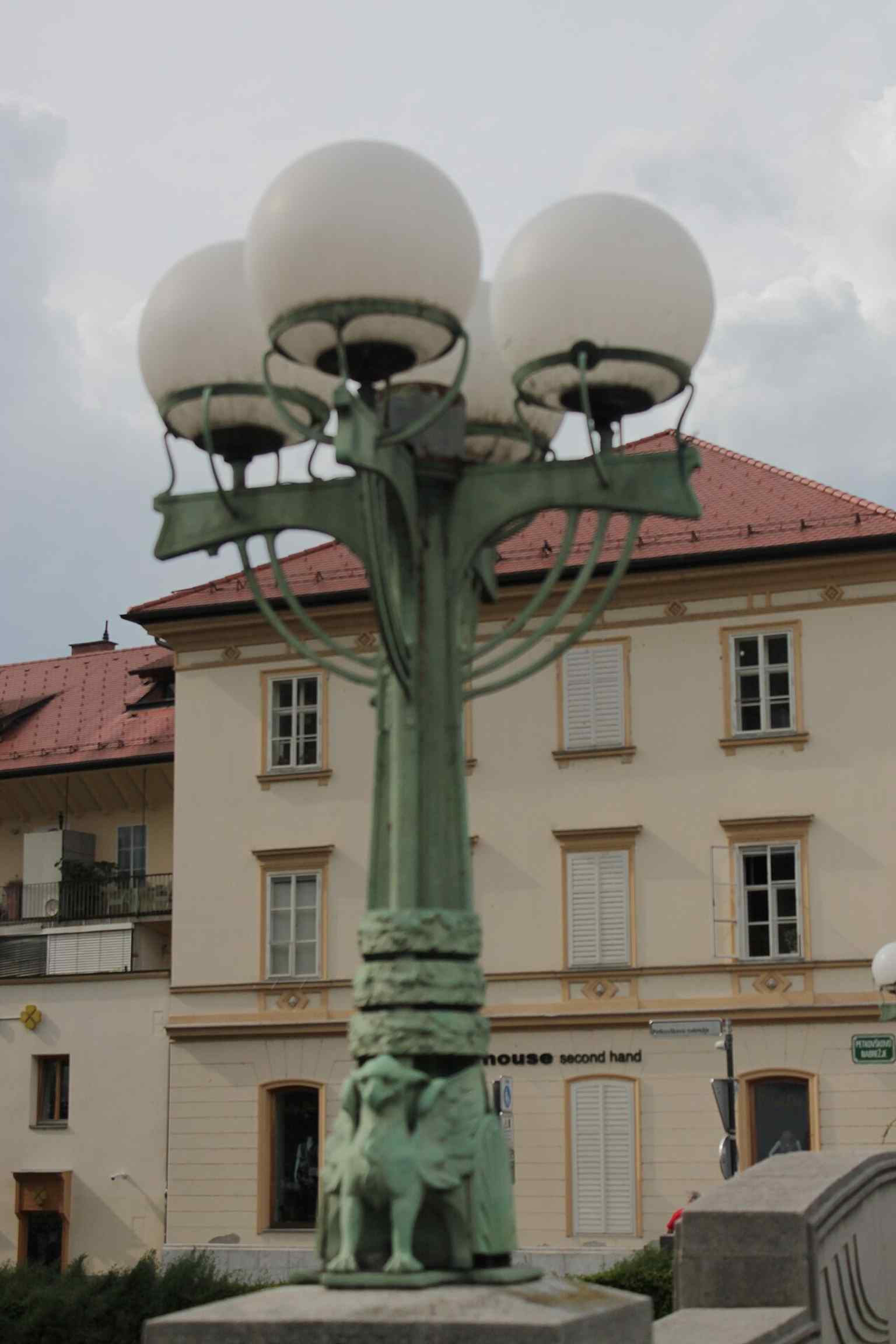 An ornate lamp post on the bridge, originally gas-fueled and now electrified, showcases the detailed Art Nouveau aesthetic envisioned by architect Jurij Zaninović for the bridge's balustrades and other decorative elements.