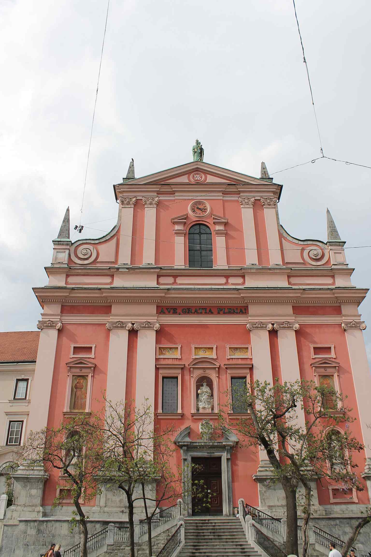 This vibrant facade, now a soft salmon-pink, was originally a bold red, symbolizing the Franciscan order, but faded over centuries to its officially protected hue.