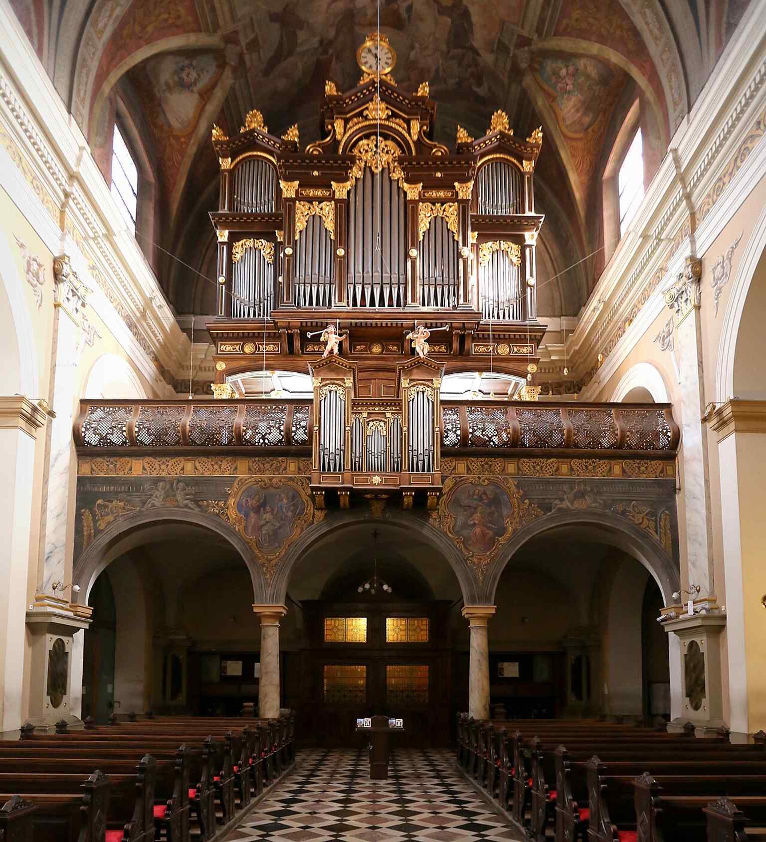 Step inside to appreciate the church's Baroque interior, which was transformed in the mid-19th century by Matevž Langus's frescoes, though much of his work was tragically ruined by the 1895 earthquake.