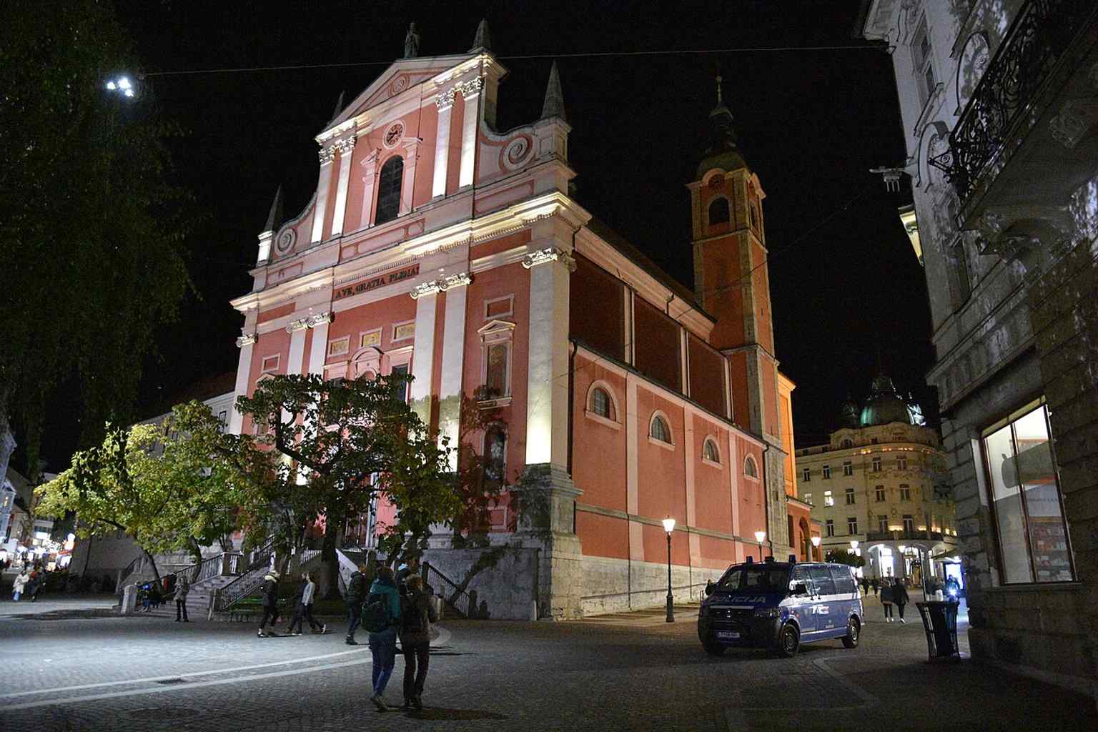 See the Franciscan Church of the Annunciation illuminated at night, a landmark originally built by the Augustinians between 1646 and 1660 before becoming a Franciscan site in the late 18th century.