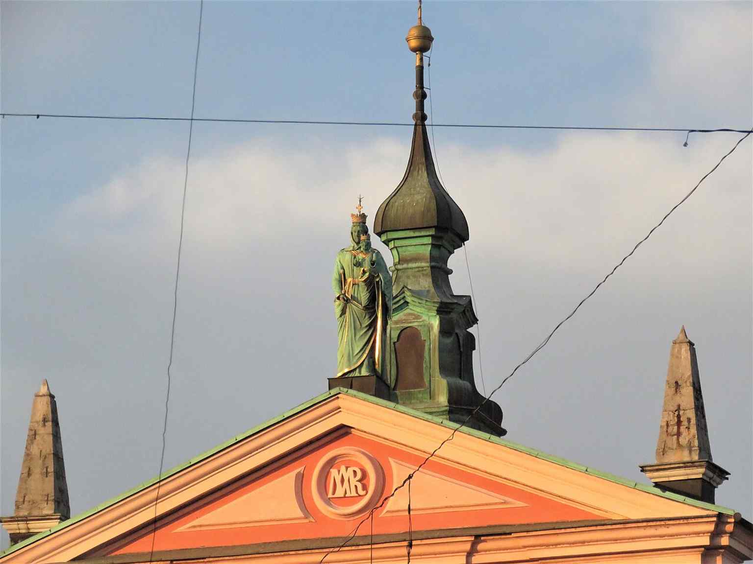 High atop the facade, this nearly four-meter-tall copper statue of Our Lady of Loretto, cast in 1858, is the largest Madonna statue in Ljubljana.