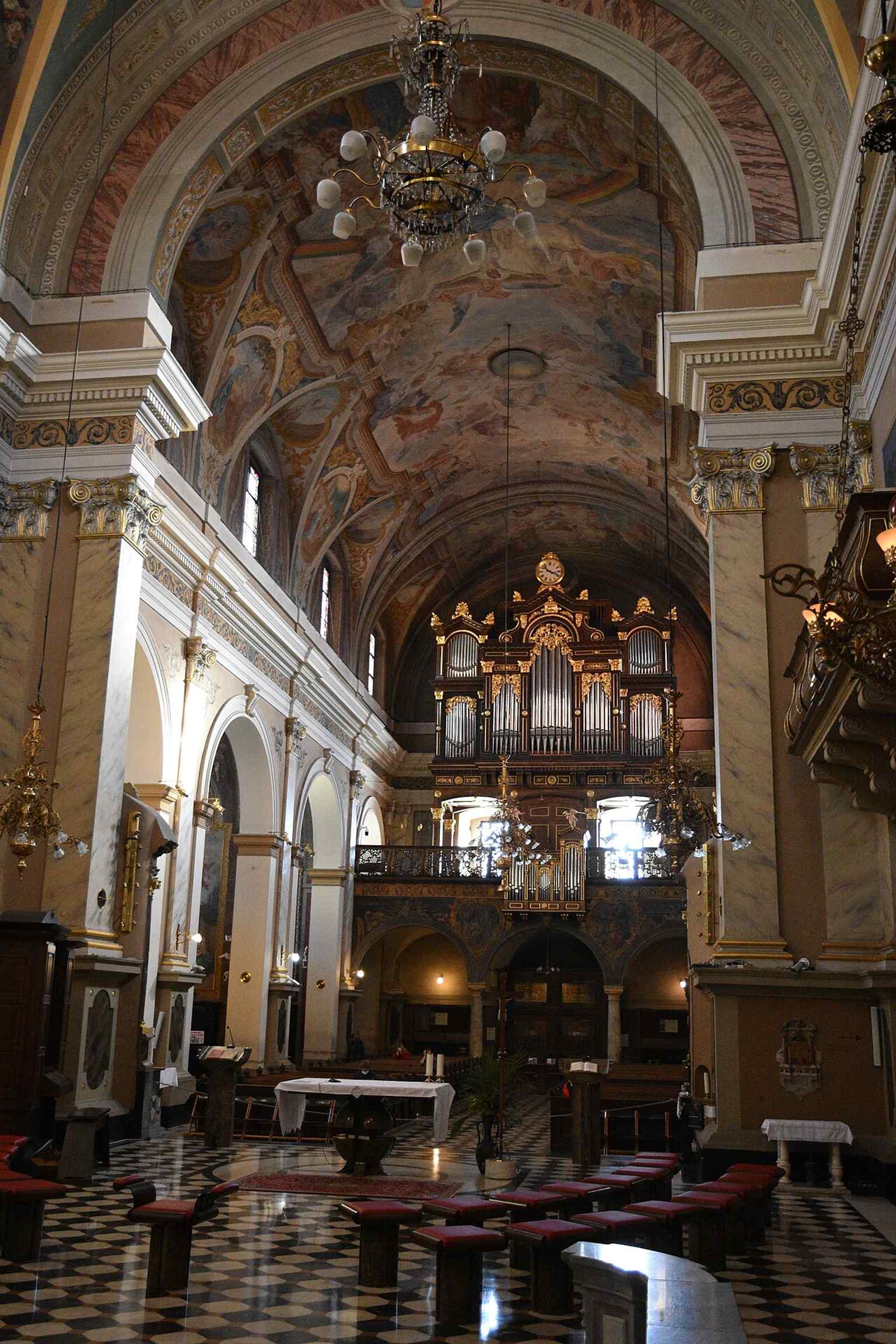 To the left of the main altar lies this glass-fronted coffin, containing the preserved skeletal remains of Saint Deodatus, offering a stark contrast to the church's gilded Baroque splendor.
