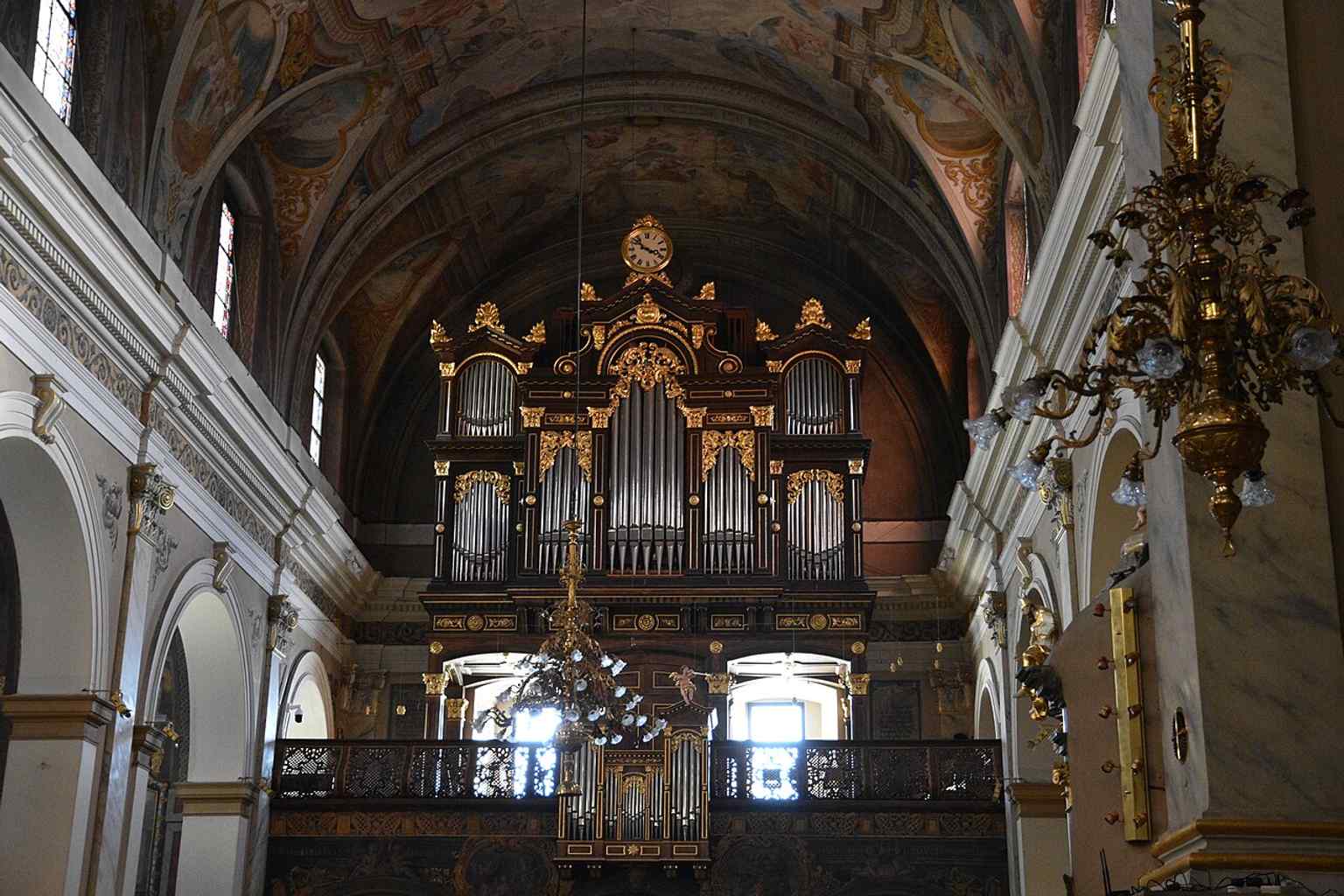 Gaze up at the ceiling frescoes, meticulously restored in the 1930s by Slovenian Impressionist Matej Sternen, who worked in the Baroque 'trompe-l'œil' style to recreate their original grandeur after the 1895 earthquake.
