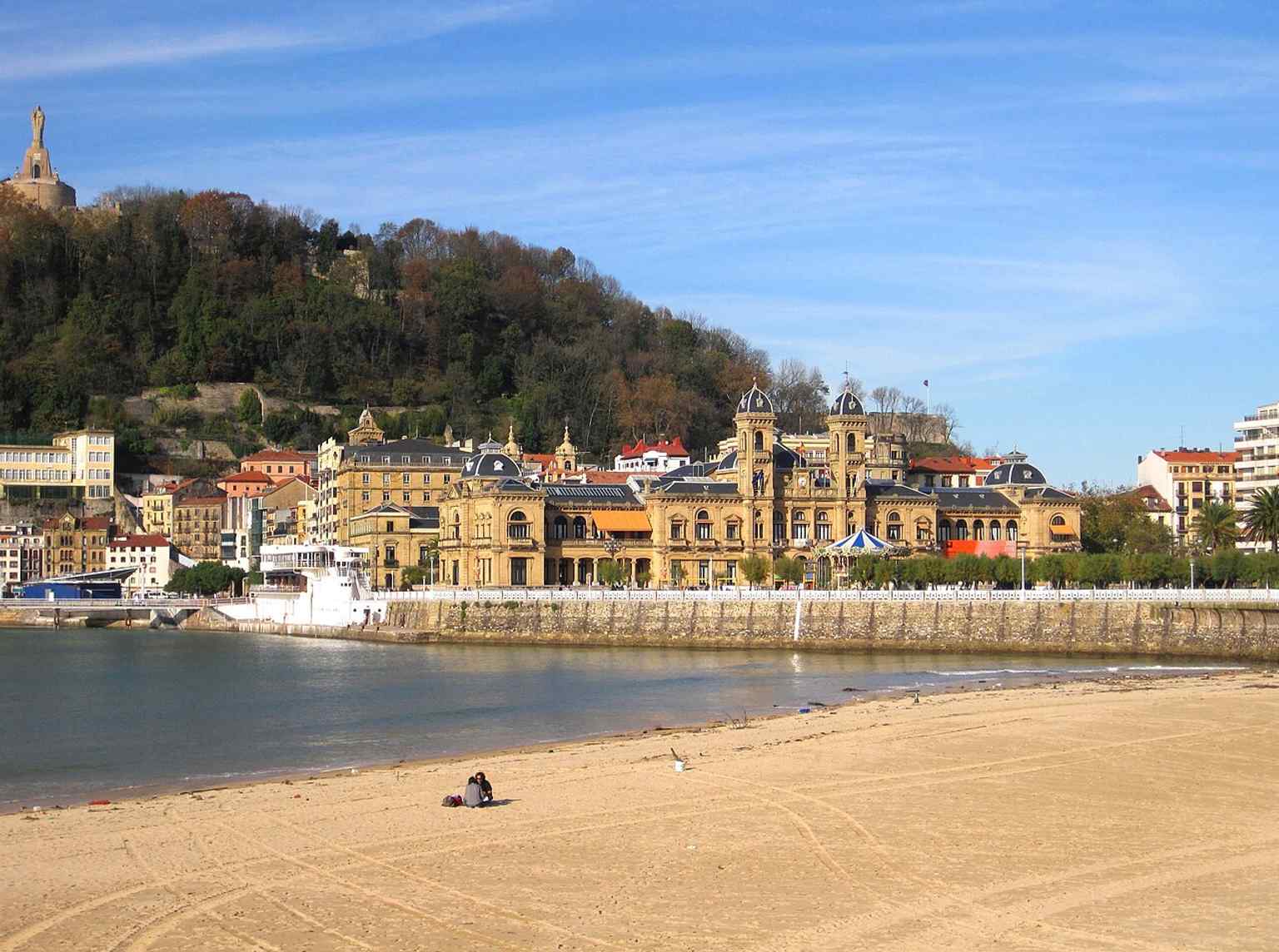 The town hall seen from La Concha beach, connecting the council building to the famous bay promenade.