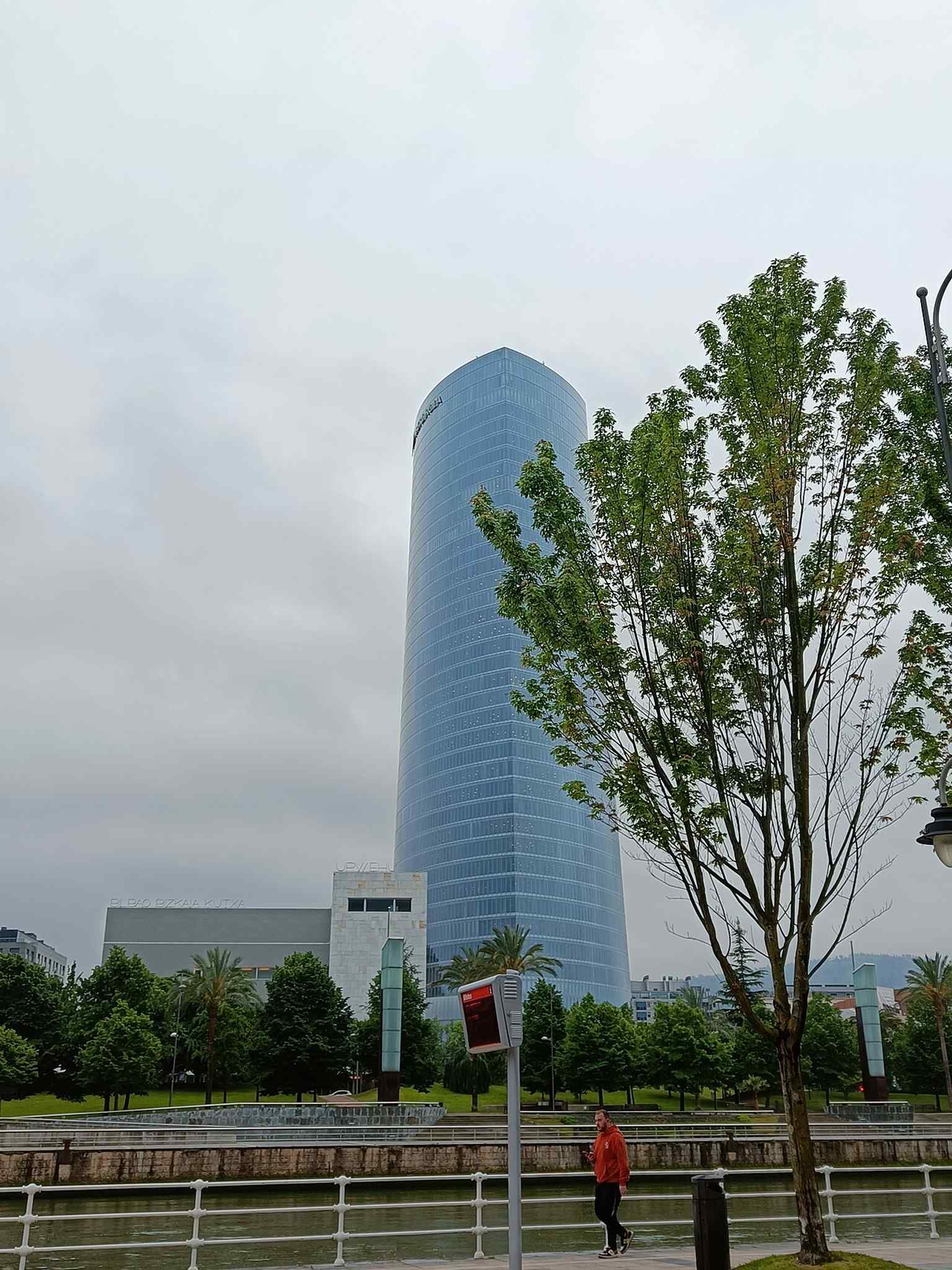 The tower across the Nervión River, showing how it anchors the regenerated riverfront next to Deusto and Abandoibarra.