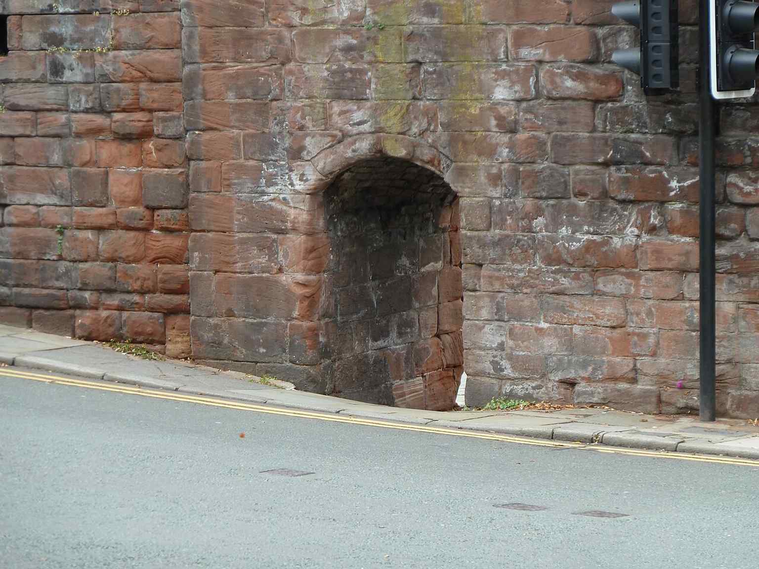 The pedestrian exit highlights how the gate still carries people over the road, just as part of Chester’s historic walls.