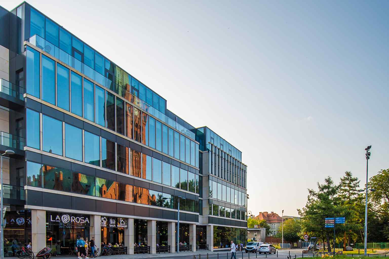 The modern Immobile K3 office block now occupies the former bus station site on Kościeleckich Square, beside St. Andrew Bobola Church.