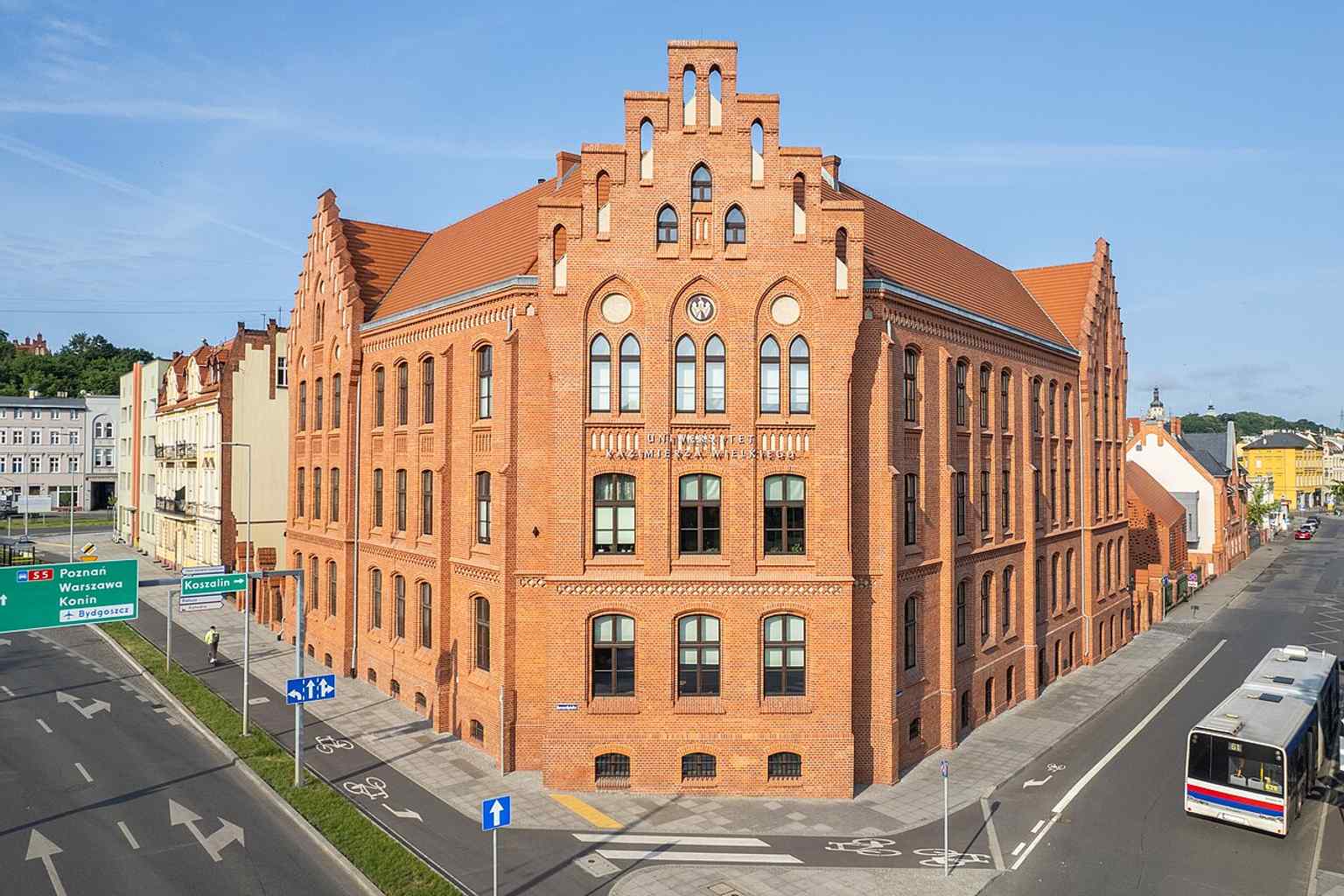 Street-level view of the building at 8 Kościeleckich Square, part of the south-side frontage that frames the square.