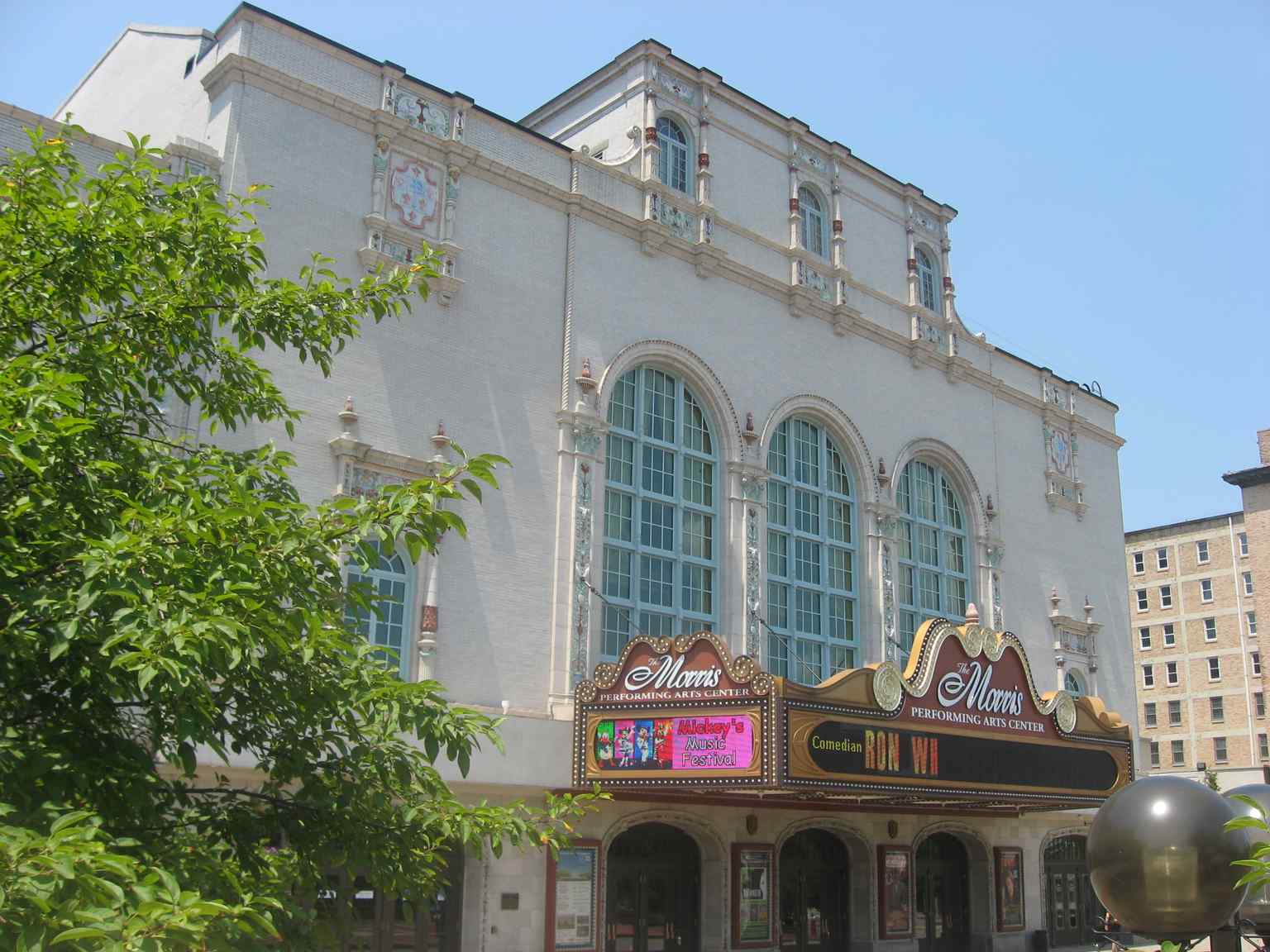 This exterior view showcases the Spanish Renaissance Revival style of the Morris Performing Arts Center, originally known as the Palace Theater and featuring finely crafted terra cotta ornamentation from its 1922 opening.