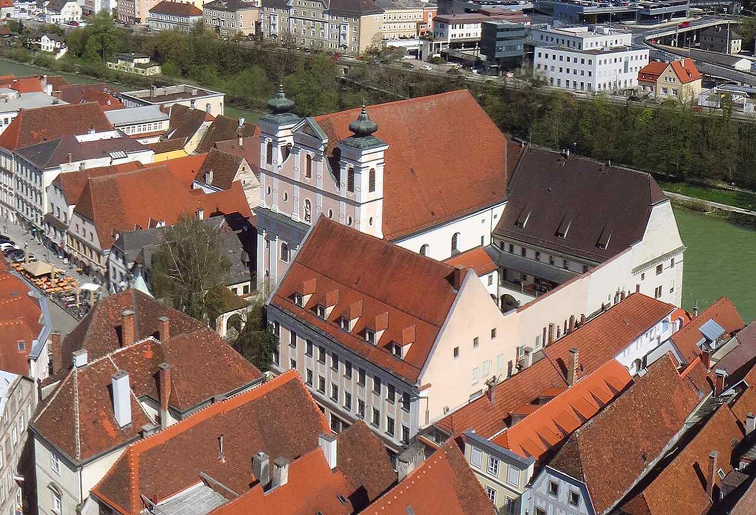 A tower view over the Marienkirche and former monastery buildings, helping place the church within Steyr’s old town ensemble.