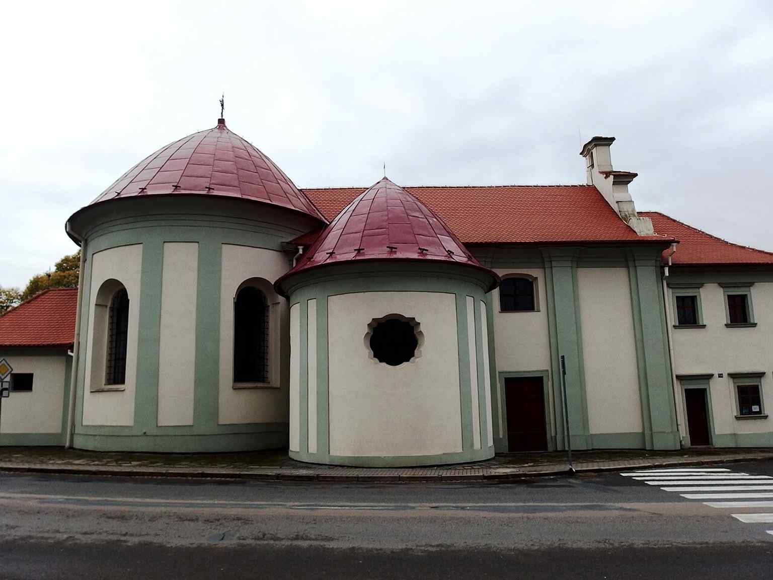 This exterior view showcases the Chapel of St. John the Baptist, a protected monument, connected to the former hospital building that has roots back to the 13th century.