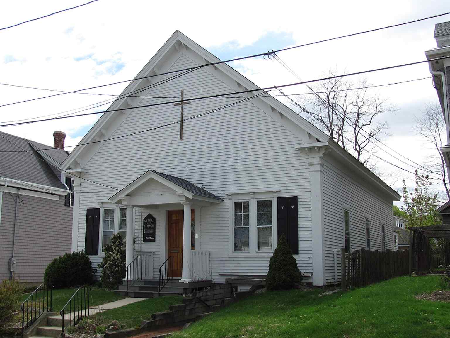 View the Bethel African Methodist Episcopal Church, originally a commercial building from the 1840s, featuring its distinctive Greek Revival-Italianate style with a gabled portico and Doric columns. This building was consecrated as a church in 1870.