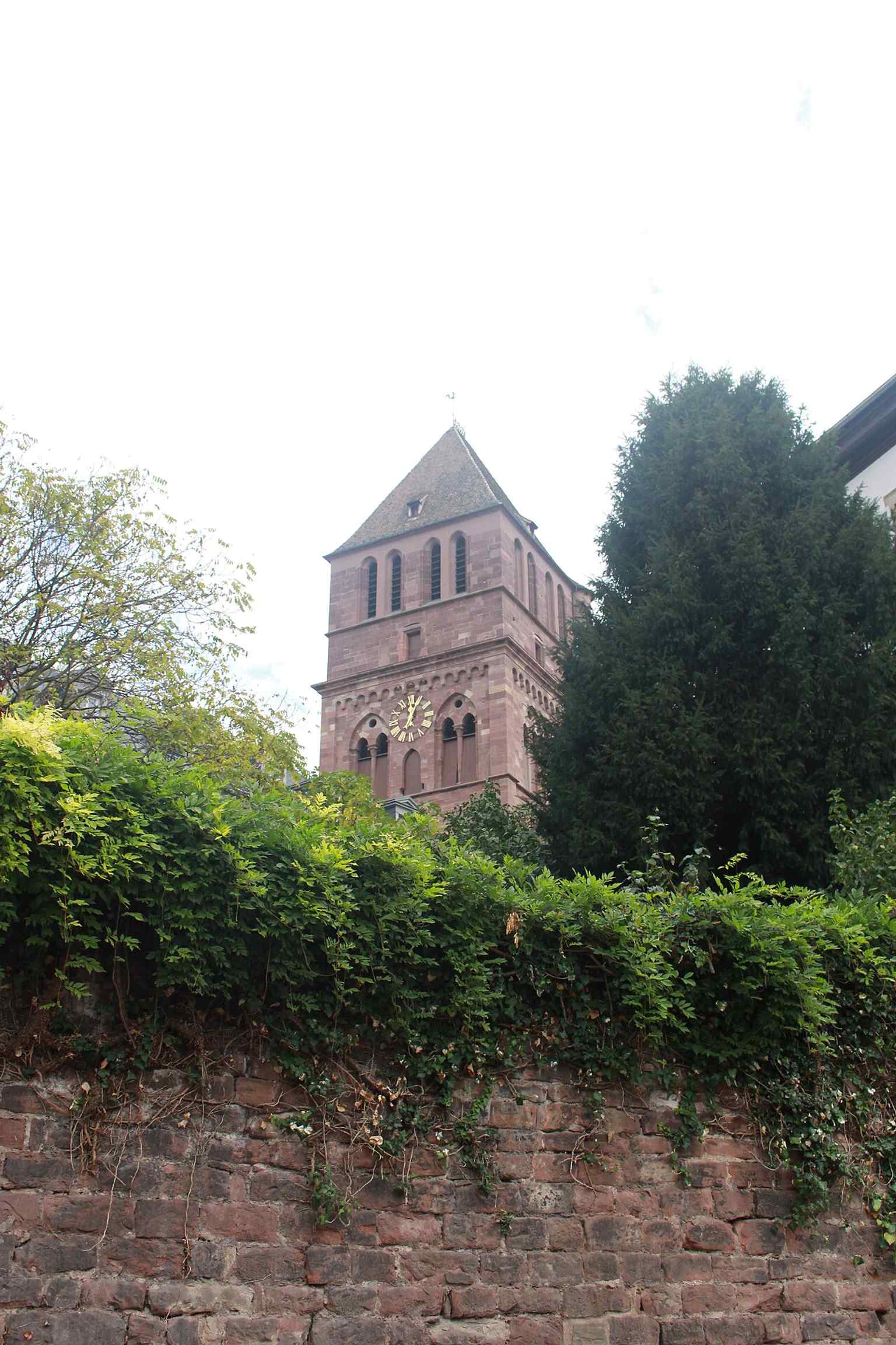 A close-up of the church tower, highlighting the Gothic silhouette that makes Saint Thomas recognizable from nearby streets.