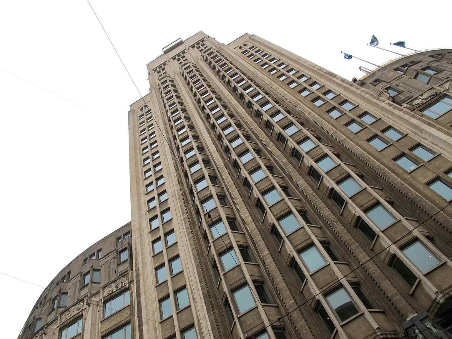 An oblique ground-level view from the base, emphasizing the tower’s height and the strong vertical lines of its Art Deco design.