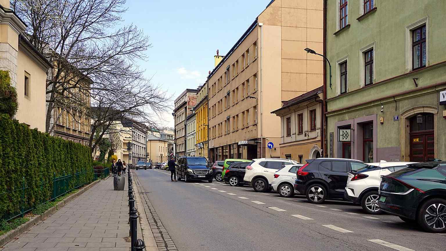 A clear eastward view along Garbarska Street in Kraków, showing the historic urban frontage of the old Garbary suburb.
