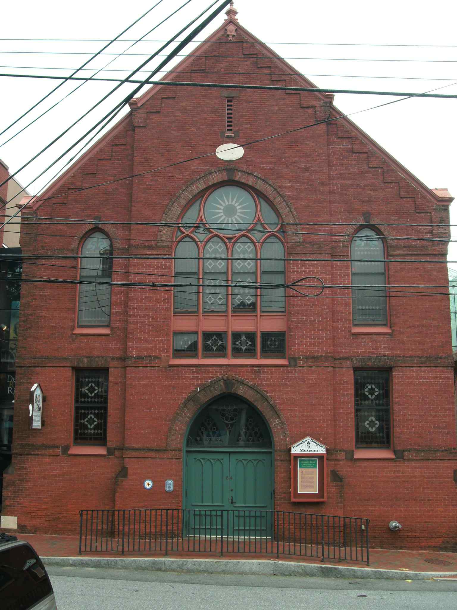 This image shows the gable-front brick church, built in 1875 in the Gothic Revival style, which now houses the Banneker-Douglass-Tubman Museum.