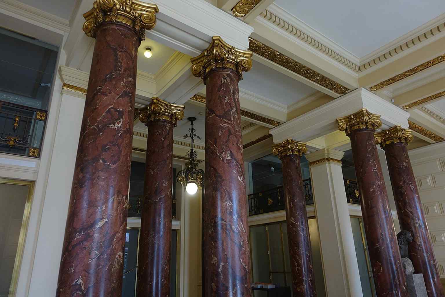A wider interior view of the foyer and circulation spaces, matching the building’s layered public rooms described in the source text.
