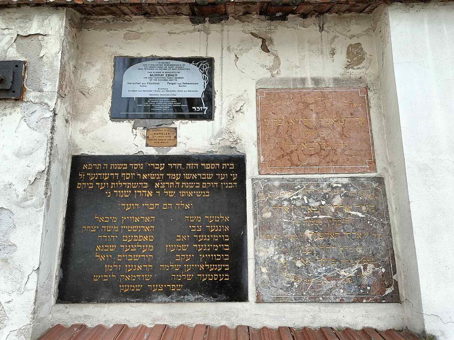 A close cemetery view that shows the crowded matzevot restored after wartime damage, when many tombstones were recovered from being reused as paving stones.