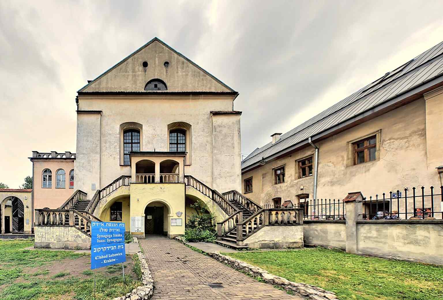 A high-resolution contemporary exterior image, showing the synagogue as a prominent monument in Kazimierz today.
