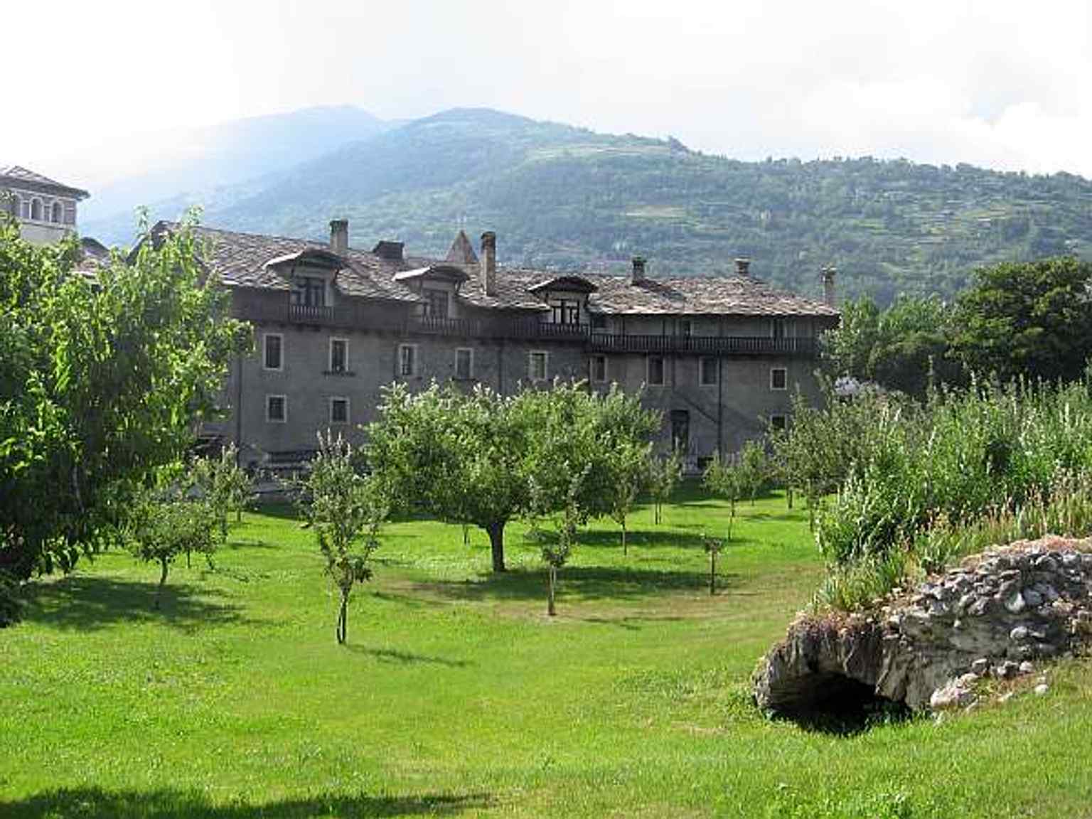 The elliptical arena of the Roman amphitheater in Aosta, which is now occupied by the convent's fruit orchard.