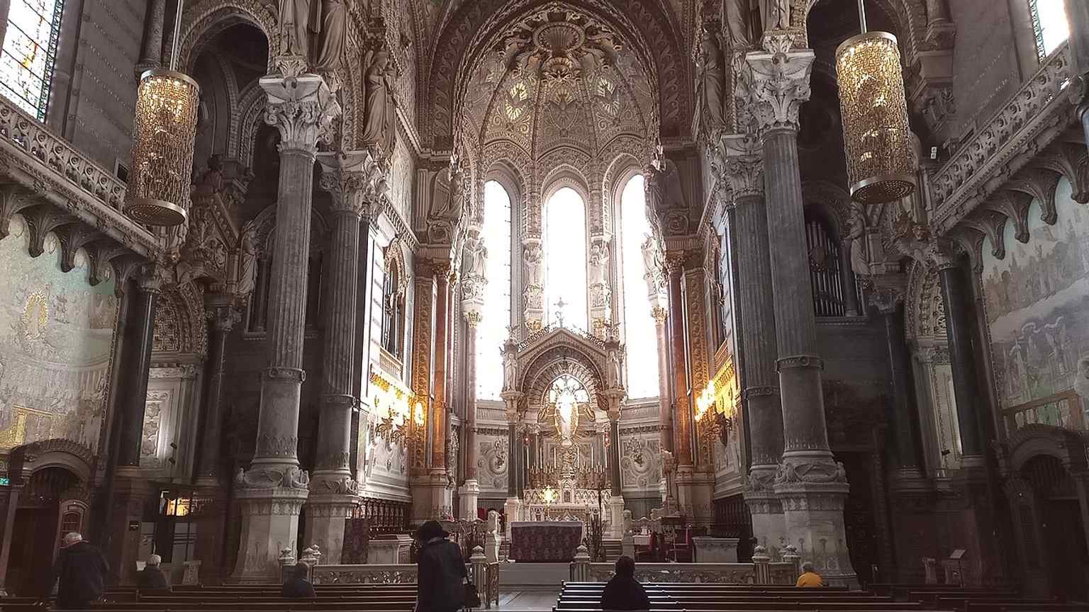 Looking into the choir highlights the basilica’s luminous upper church, the destination of the symbolic ascent from the darker lower level.
